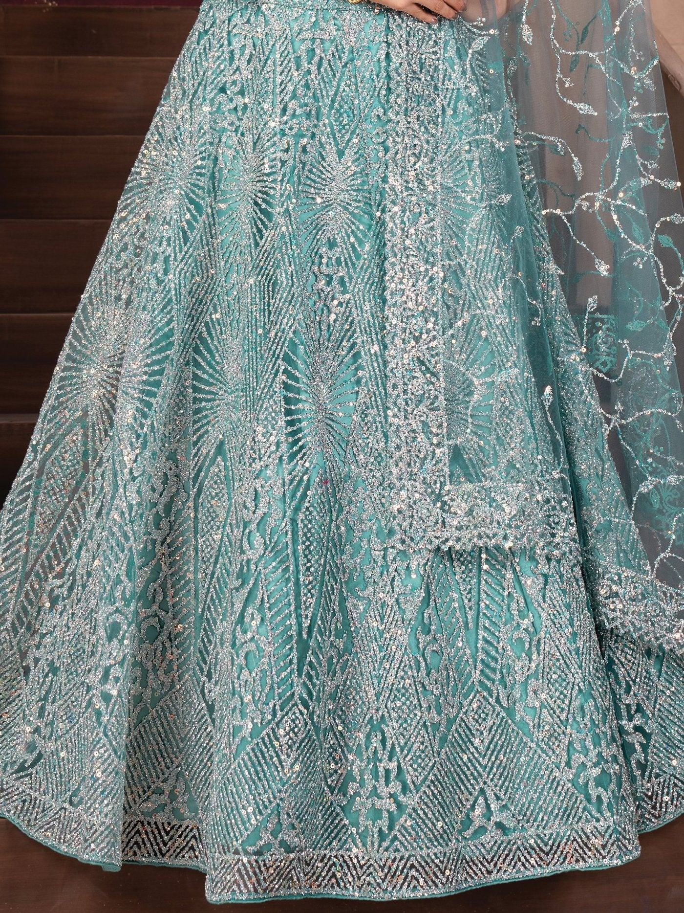 Teal designer lehenga with intricate silver embroidery and sequin work, perfect for Indian ethnic wear.