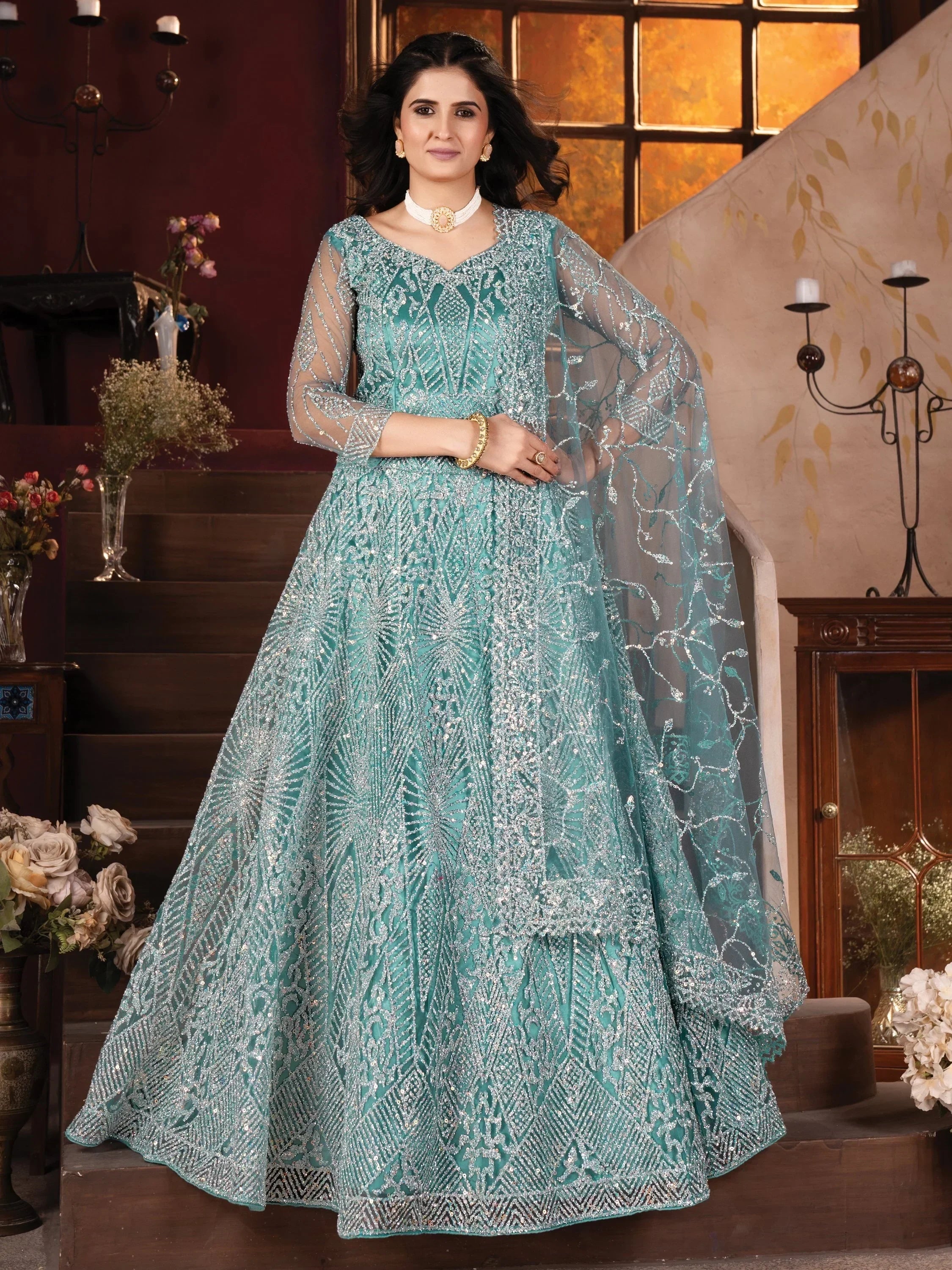 Teal designer lehenga choli with silver embroidery and sheer dupatta, perfect for Indian ethnic wear occasions