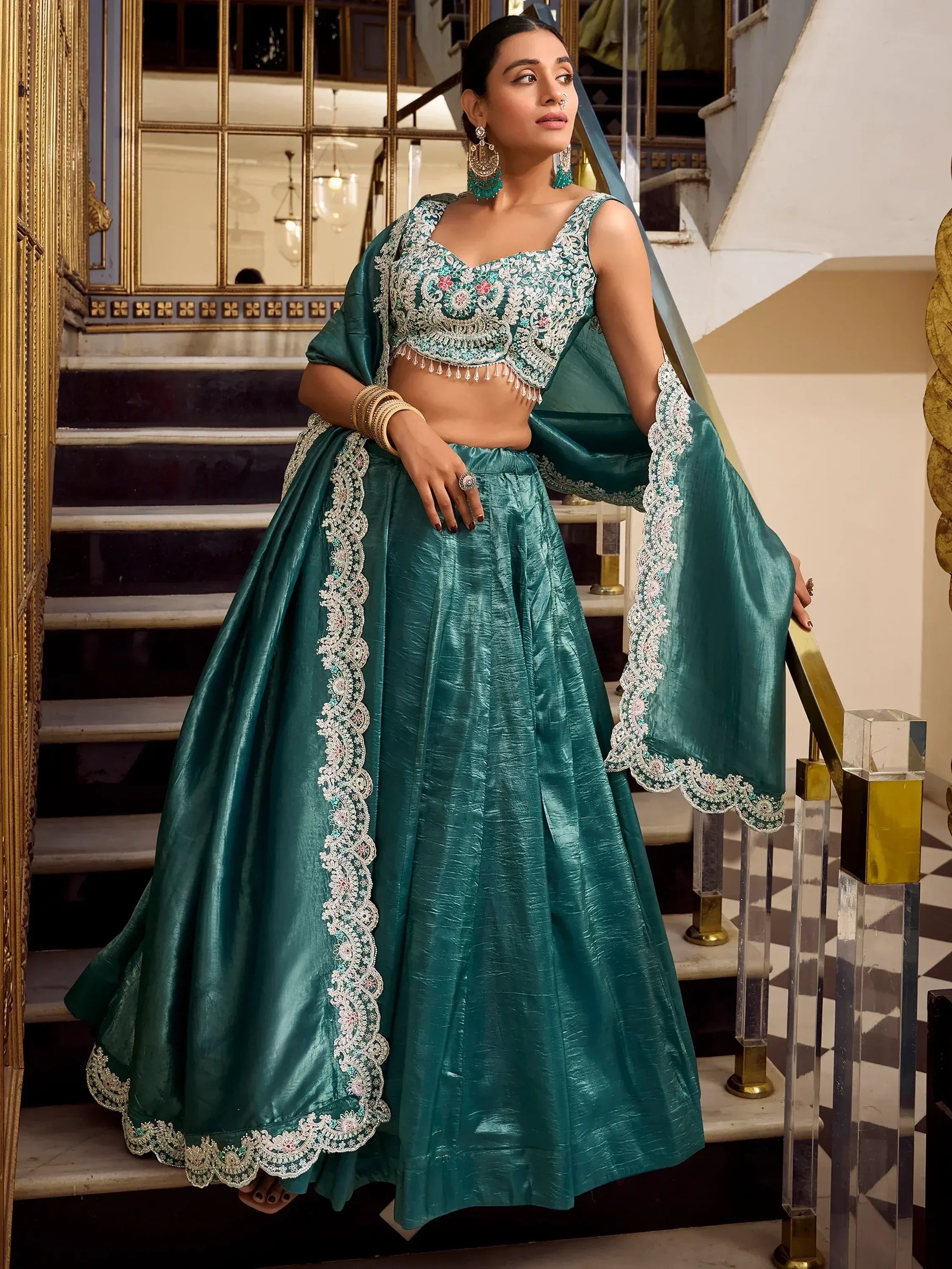 Teal green embroidered lehenga choli with lace detailing, perfect for Indian ethnic occasions