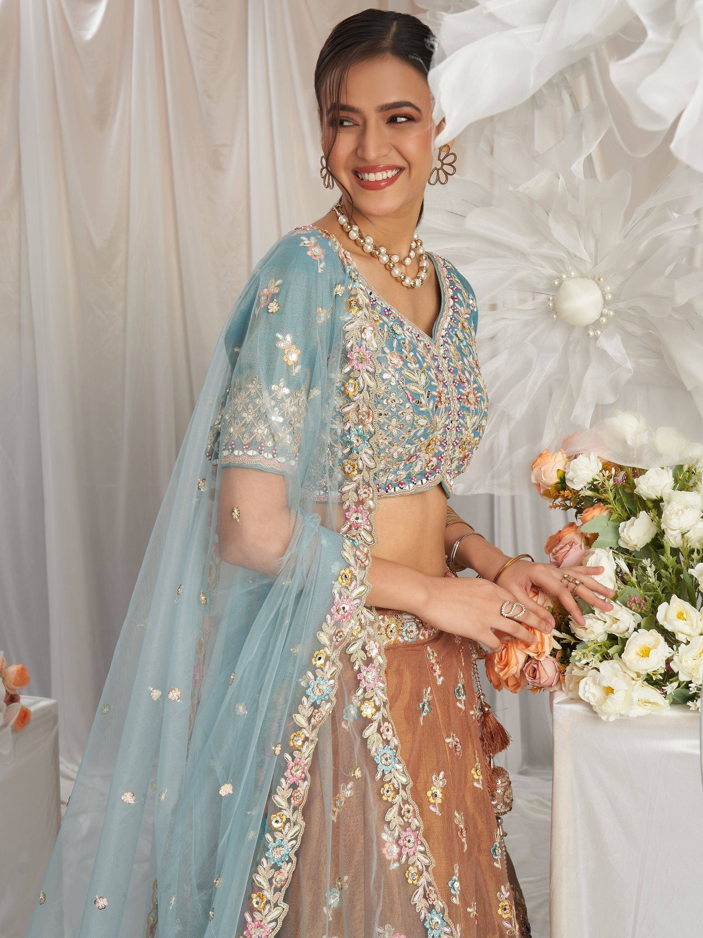 Blue and brown embroidered lehenga choli with floral detailing, perfect for Indian ethnic occasions