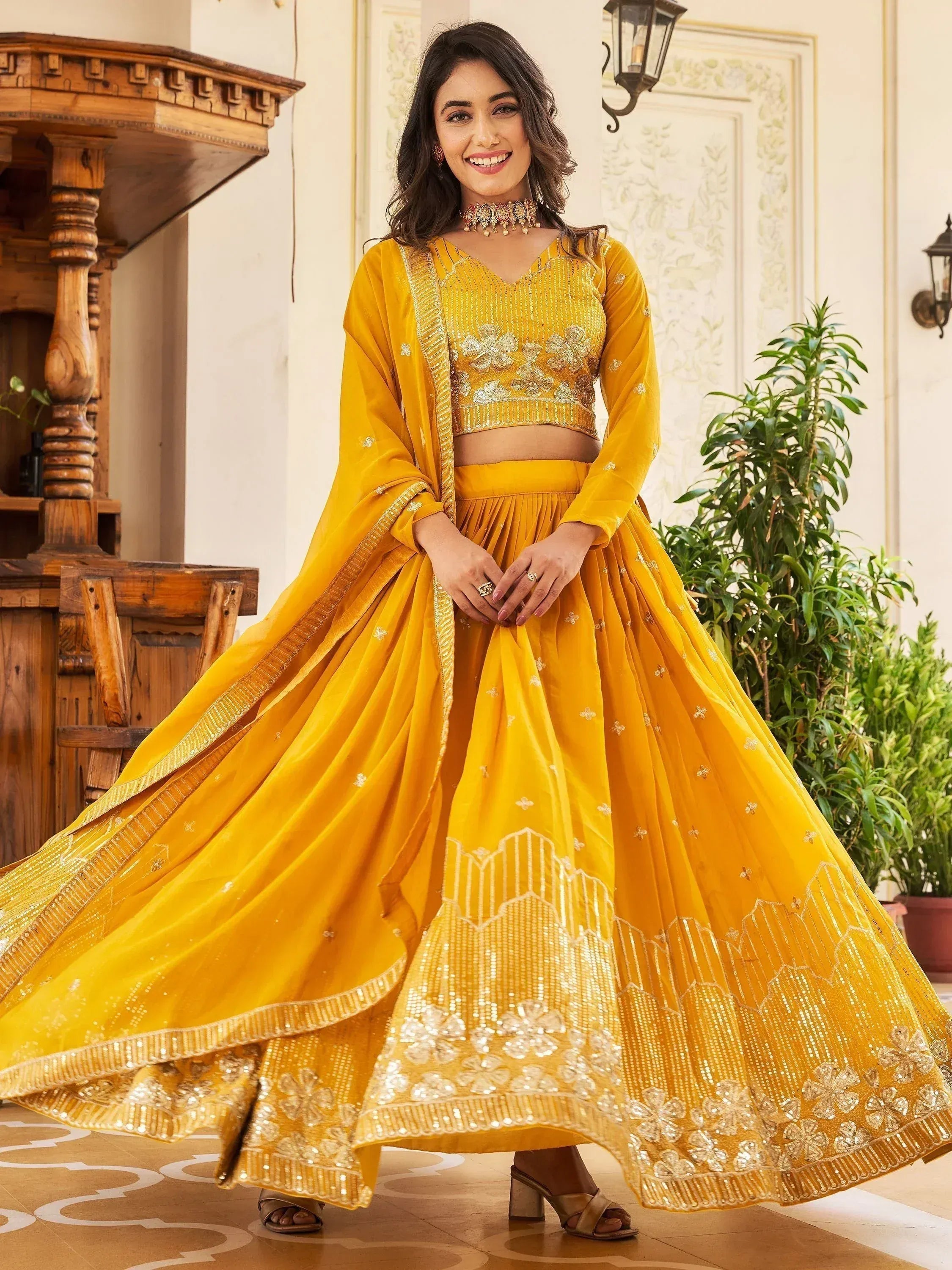 Yellow designer lehenga choli with gold embroidery and sequins, perfect for Indian ethnic occasions