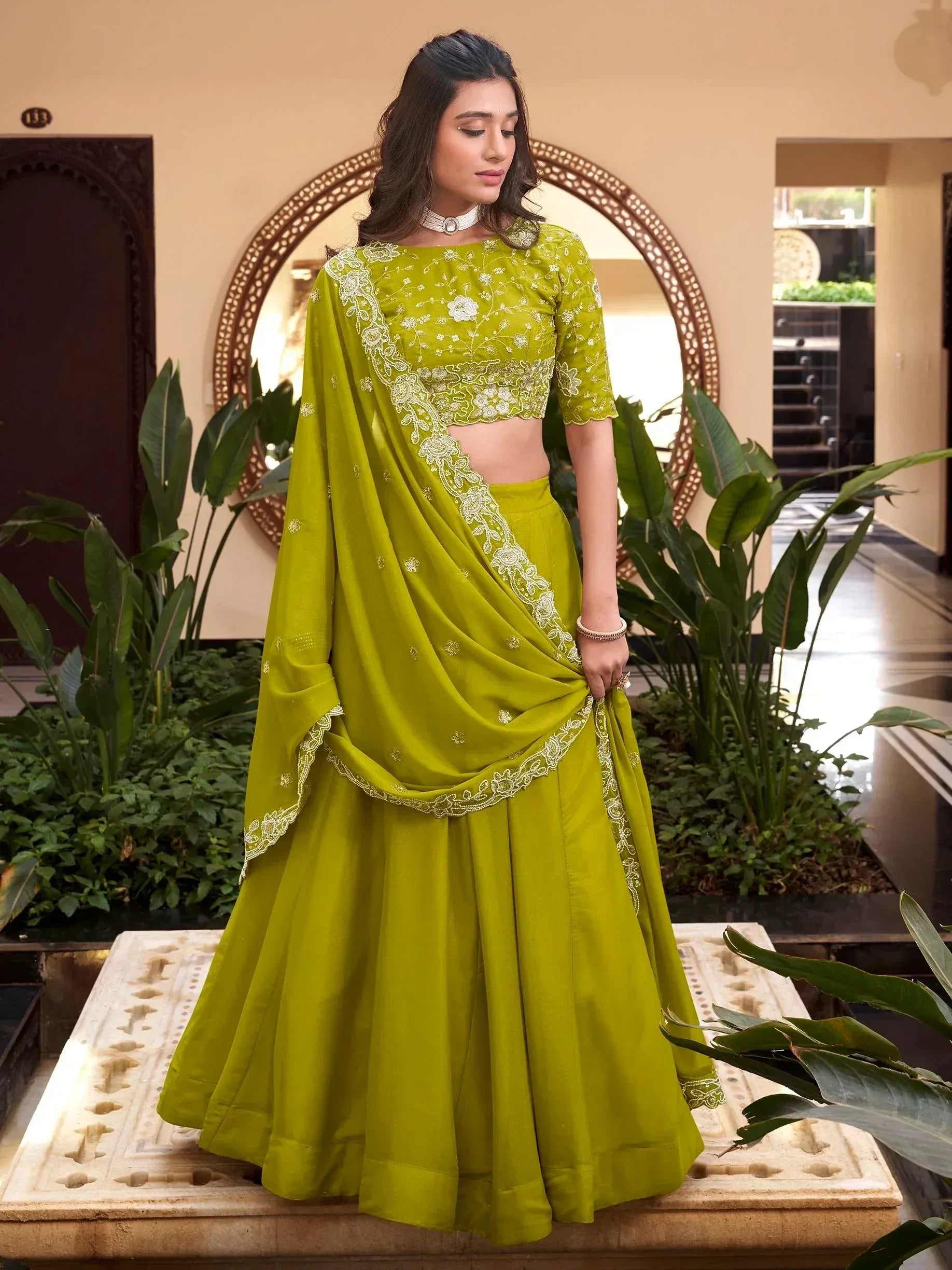 Vibrant green embroidered lehenga choli with floral detailing, perfect for Indian ethnic occasions.