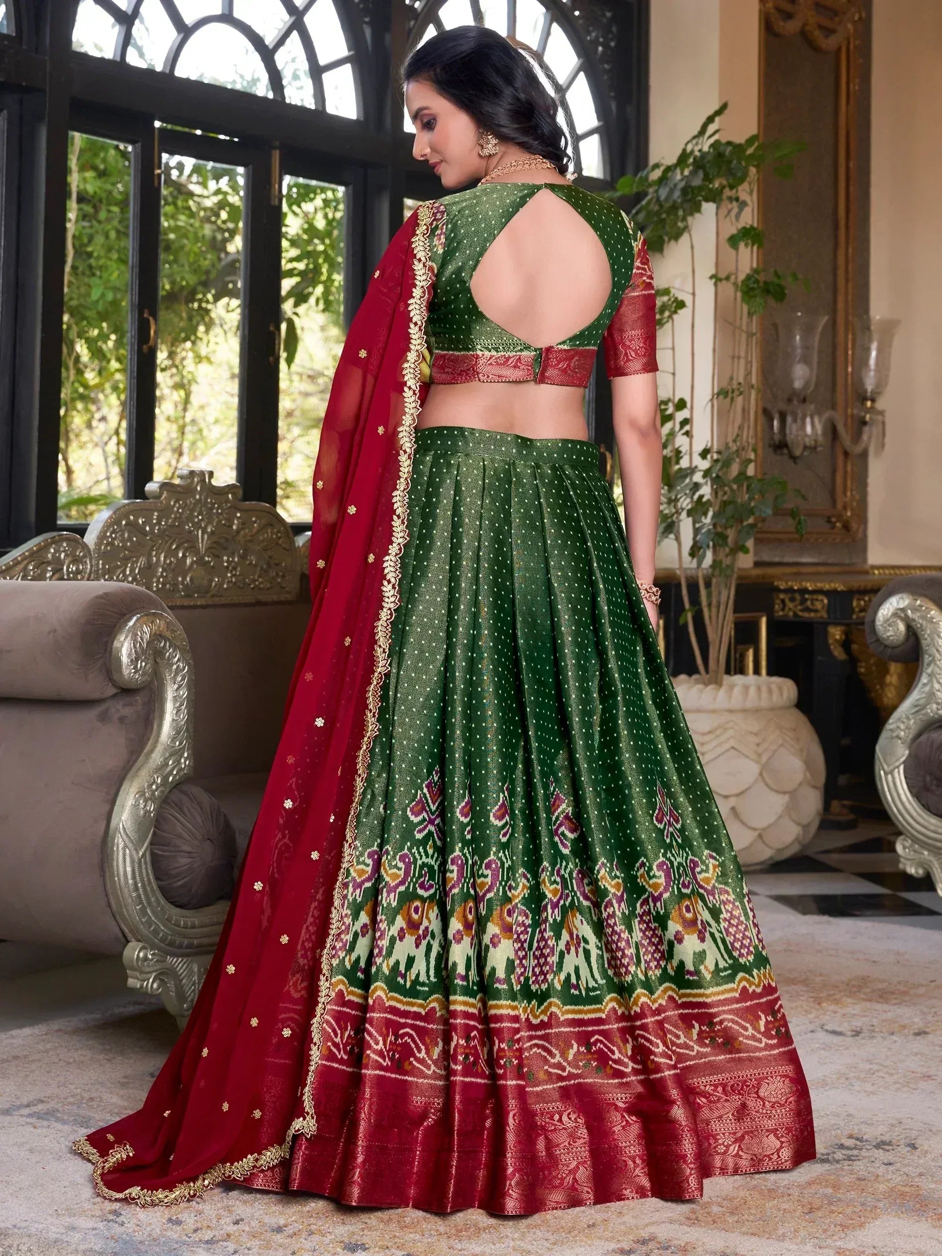 Green and red designer lehenga choli with backless blouse and ikat print, perfect for Indian ethnic occasions