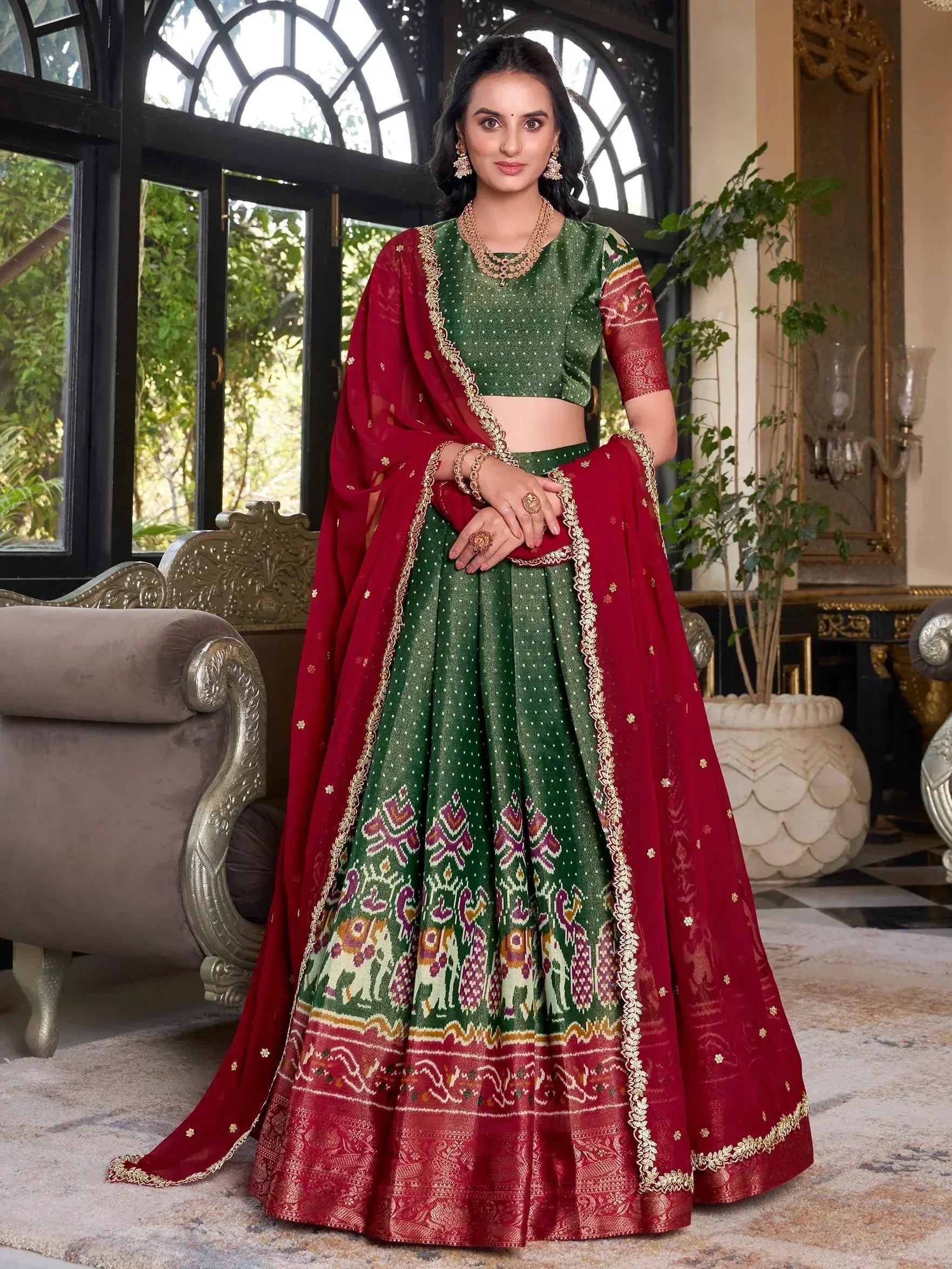Green and maroon designer lehenga choli with elephant print, perfect for Indian weddings and festive occasions.