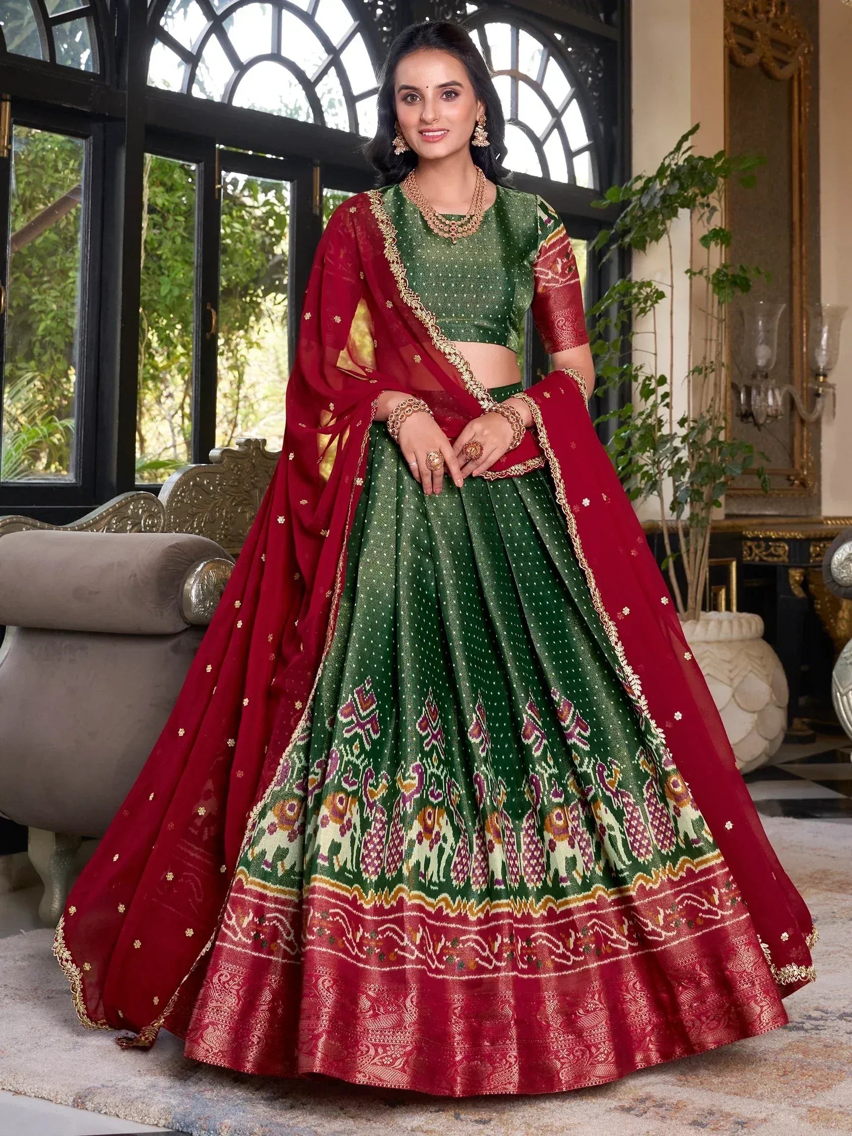Green and red designer lehenga choli with elephant print, perfect for Indian ethnic wear and festive occasions.