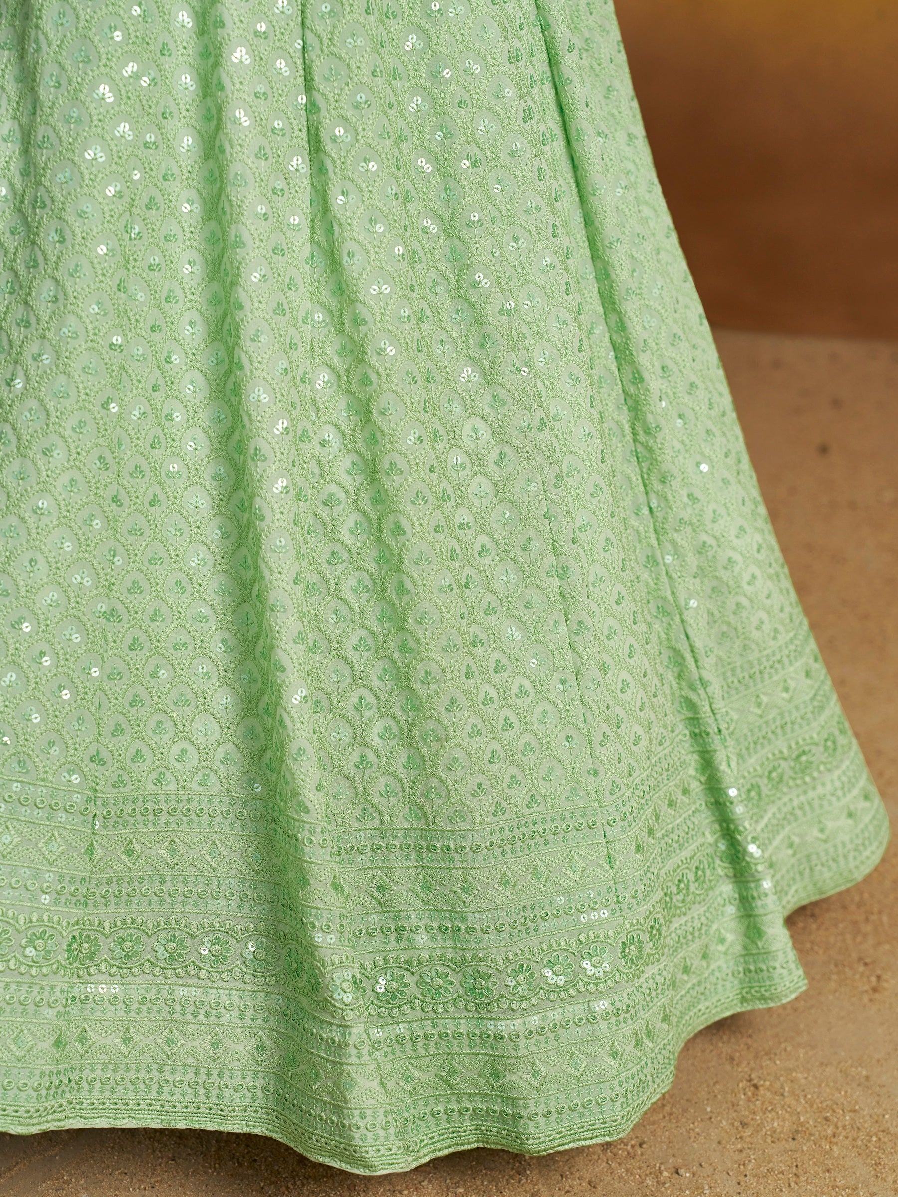 Mint green ethnic gown with floral embroidery and sequin detailing, perfect for Indian occasions