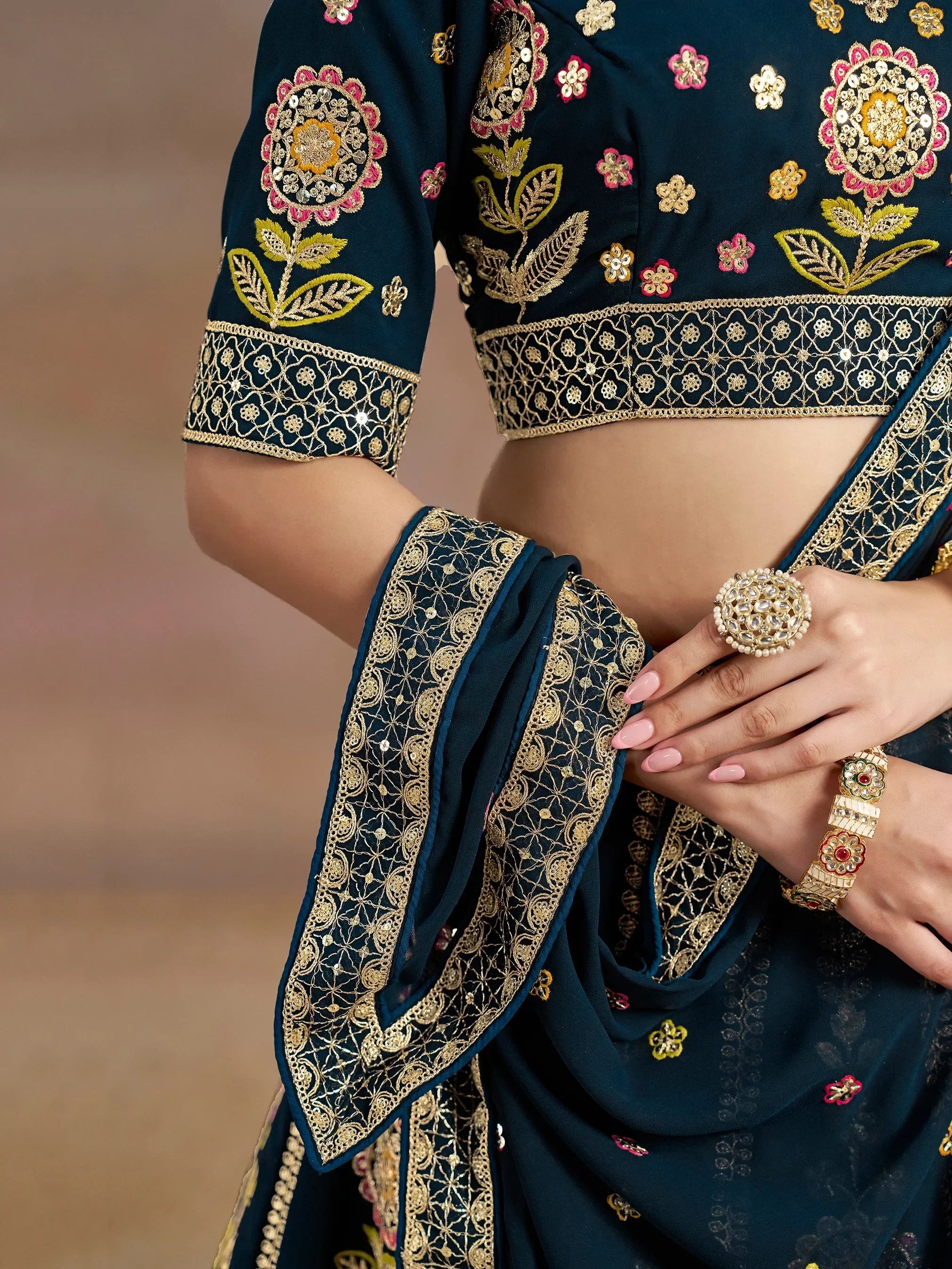 Dark blue embroidered lehenga choli with gold floral motifs and intricate border detailing