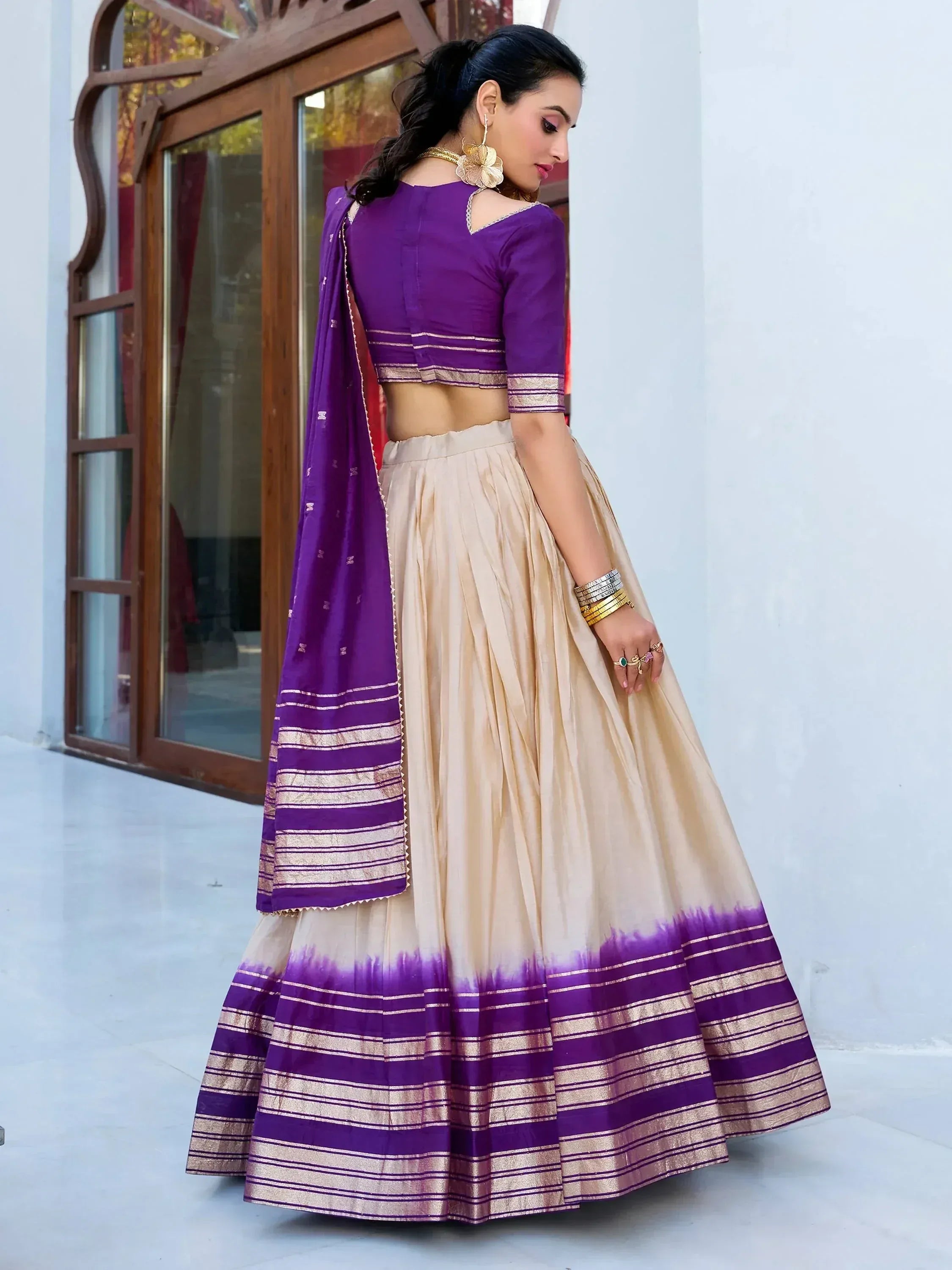 Purple and beige lehenga choli with gold trim, perfect for Indian ethnic wear and festive occasions.