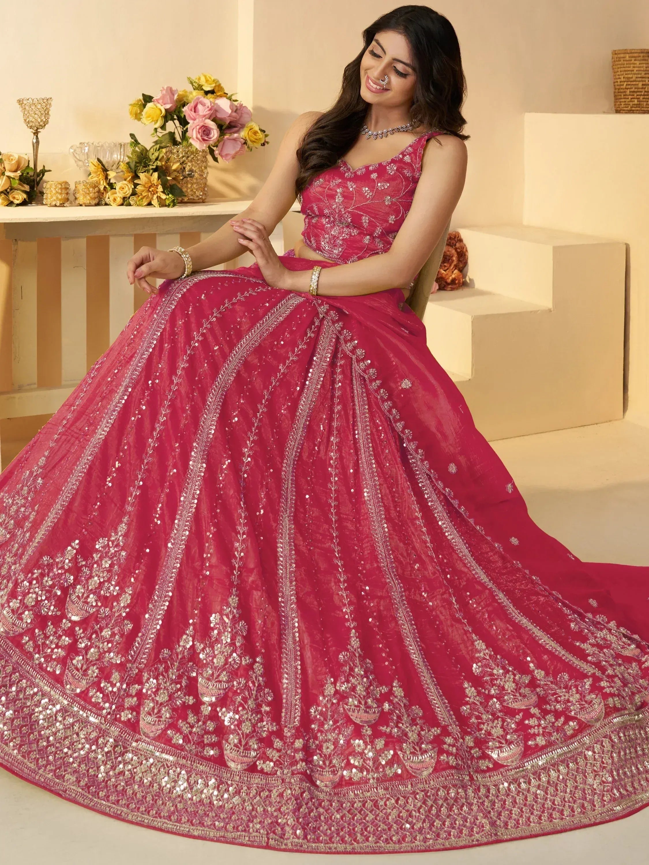 Pink designer lehenga choli with intricate silver embroidery and sequins, perfect for Indian weddings and festive occasions.