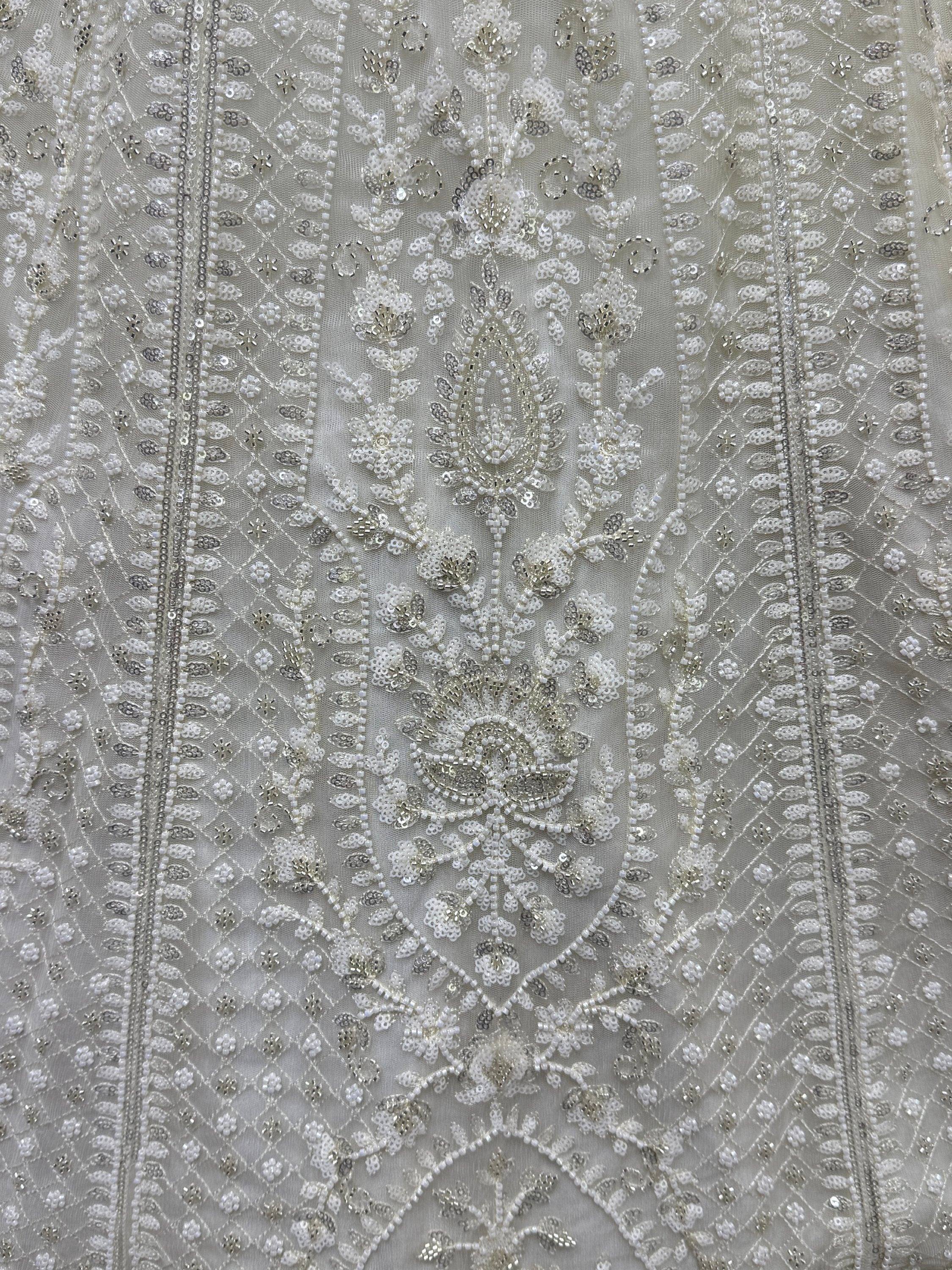 Elegant white ethnic wear with intricate bead and sequin embroidery, perfect for designer lehenga or saree.