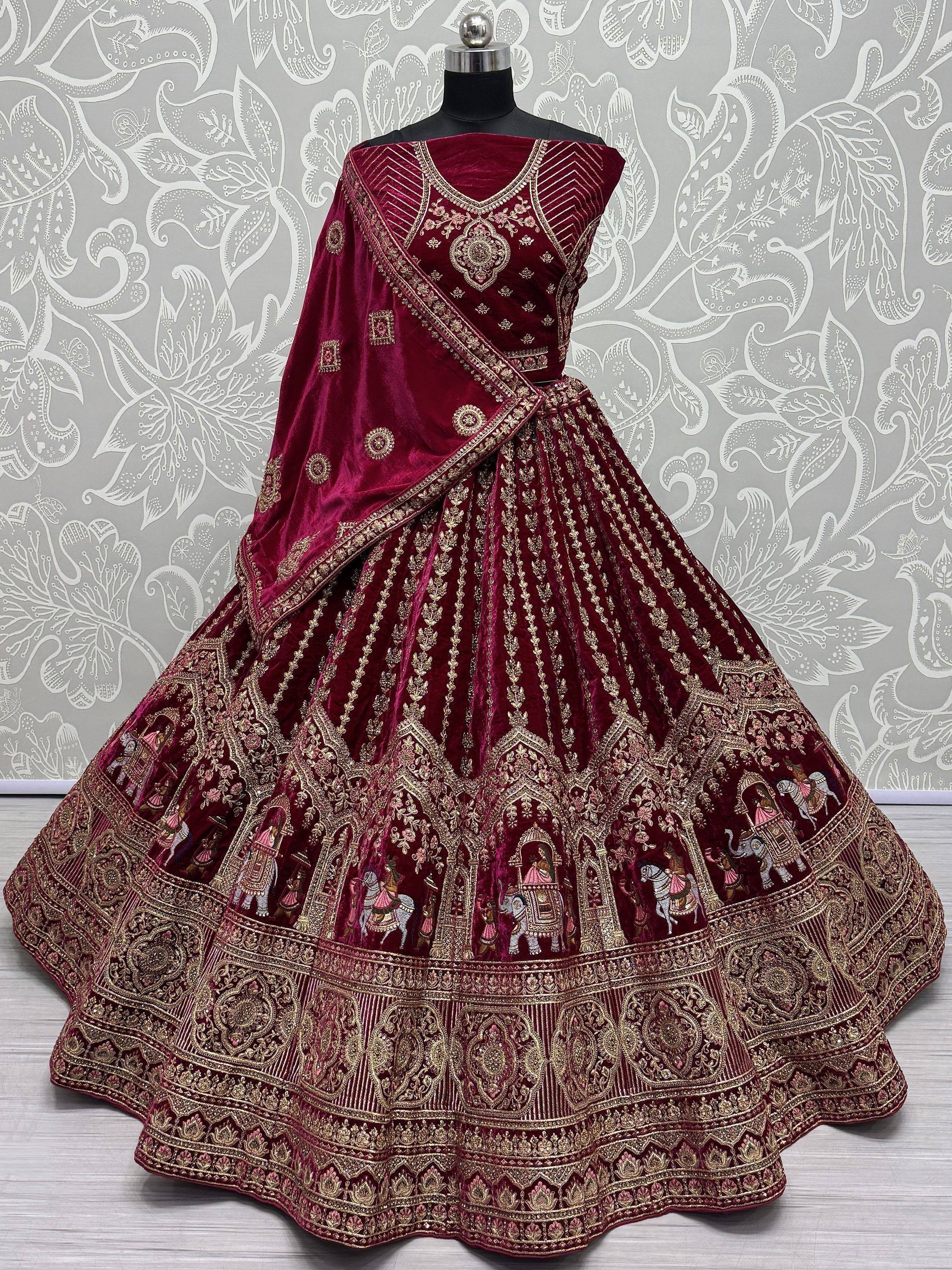 Maroon velvet lehenga choli with gold embroidery and royal motifs, ideal for Indian weddings and festive occasions.
