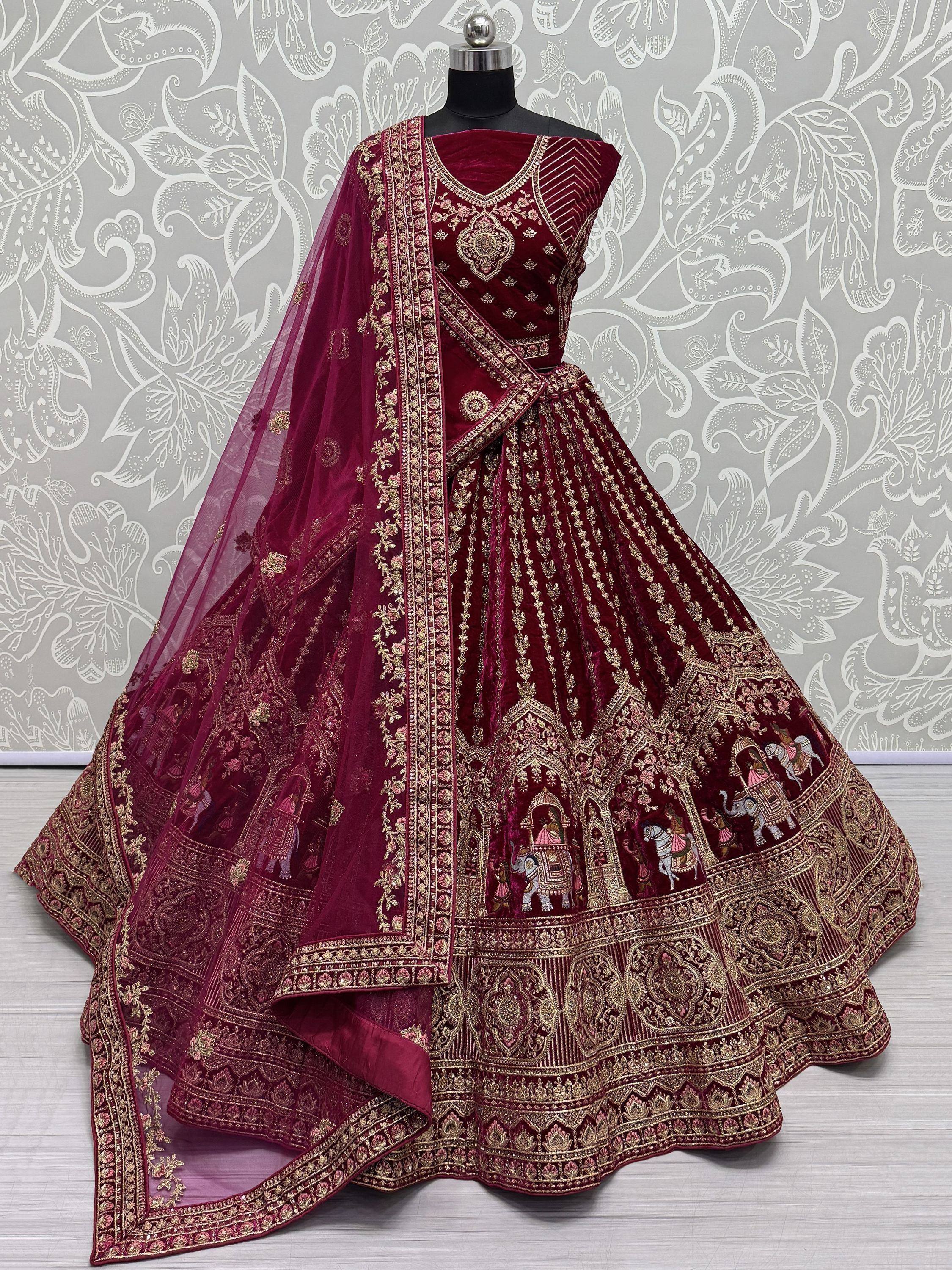 Maroon velvet lehenga choli with gold embroidery and elephant motifs, perfect for Indian weddings and festive occasions.