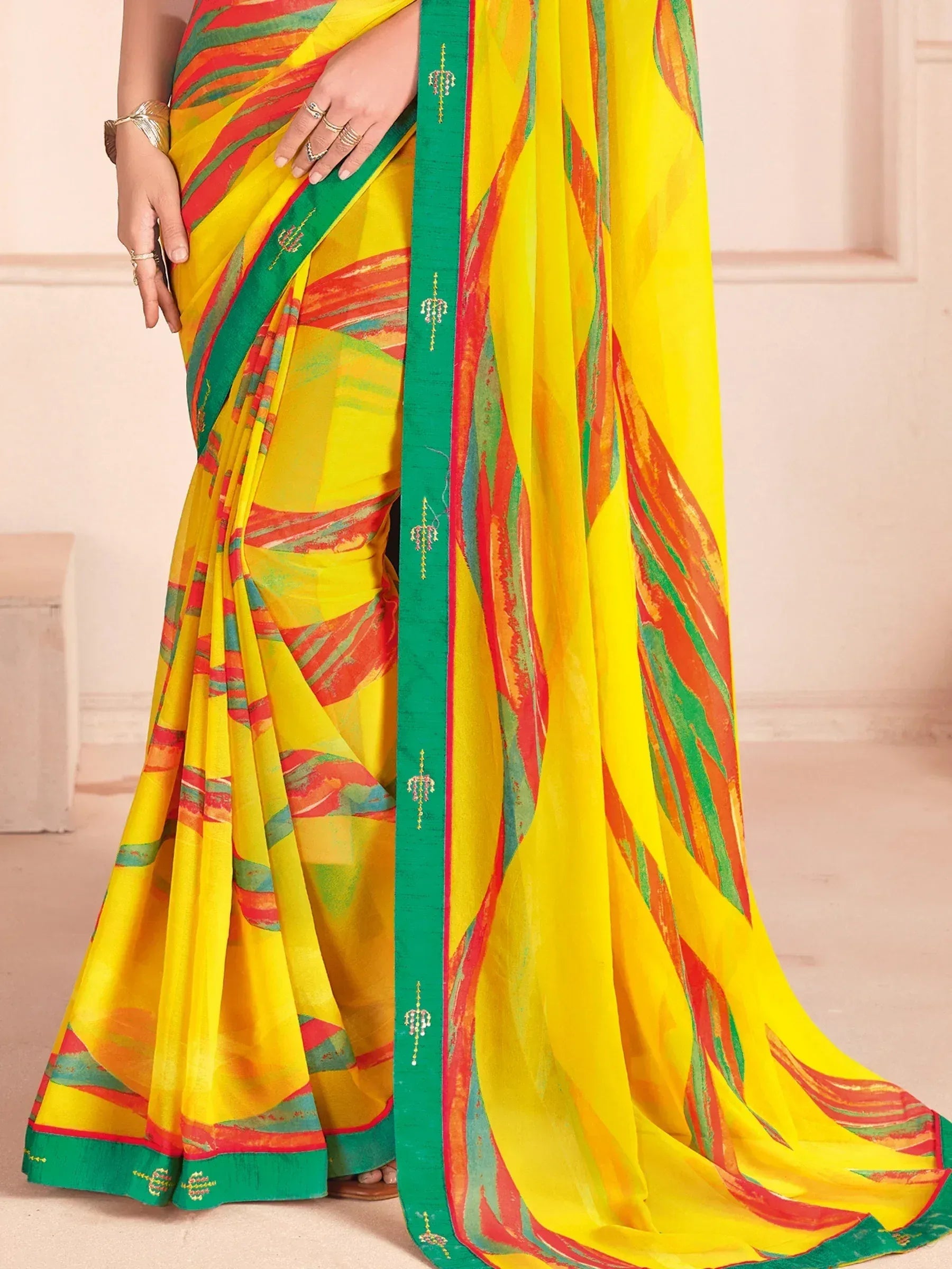 Vibrant yellow saree with red green abstract print and embroidered border, perfect for Indian ethnic wear
