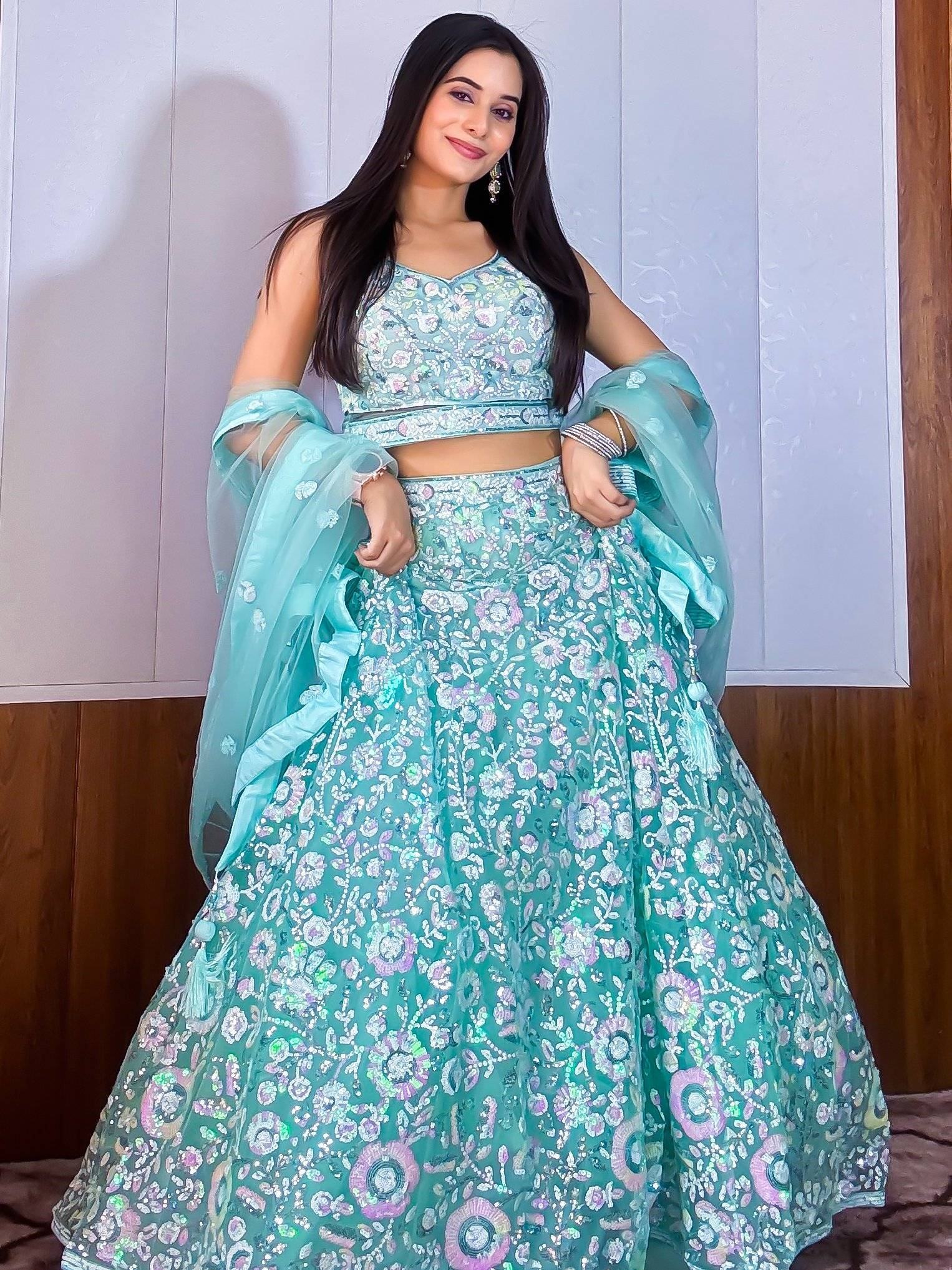 Turquoise floral embroidered lehenga choli with sheer dupatta, perfect for Indian ethnic occasions
