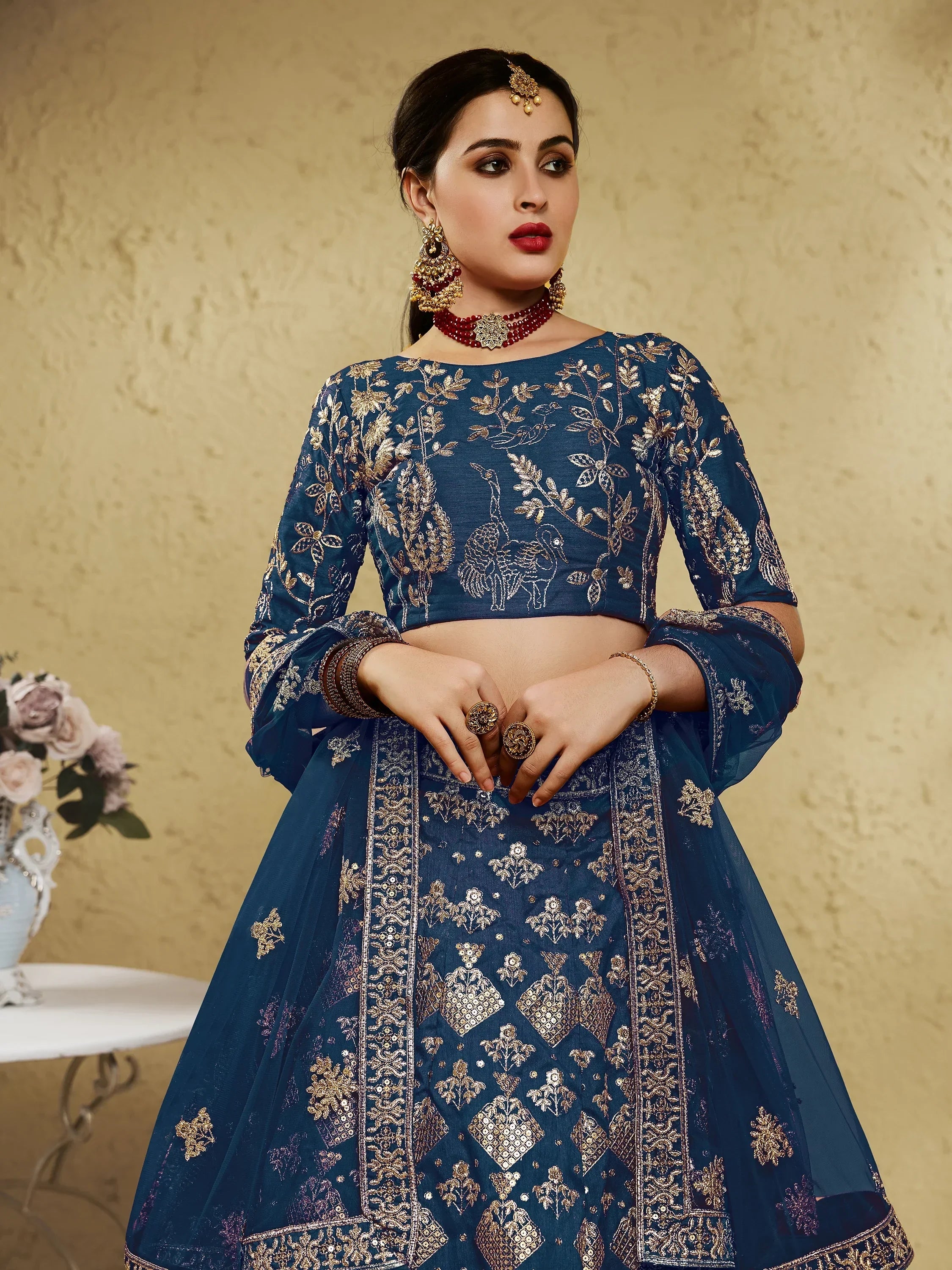 Blue embroidered lehenga choli with gold peacock motifs, perfect for Indian ethnic wear occasions