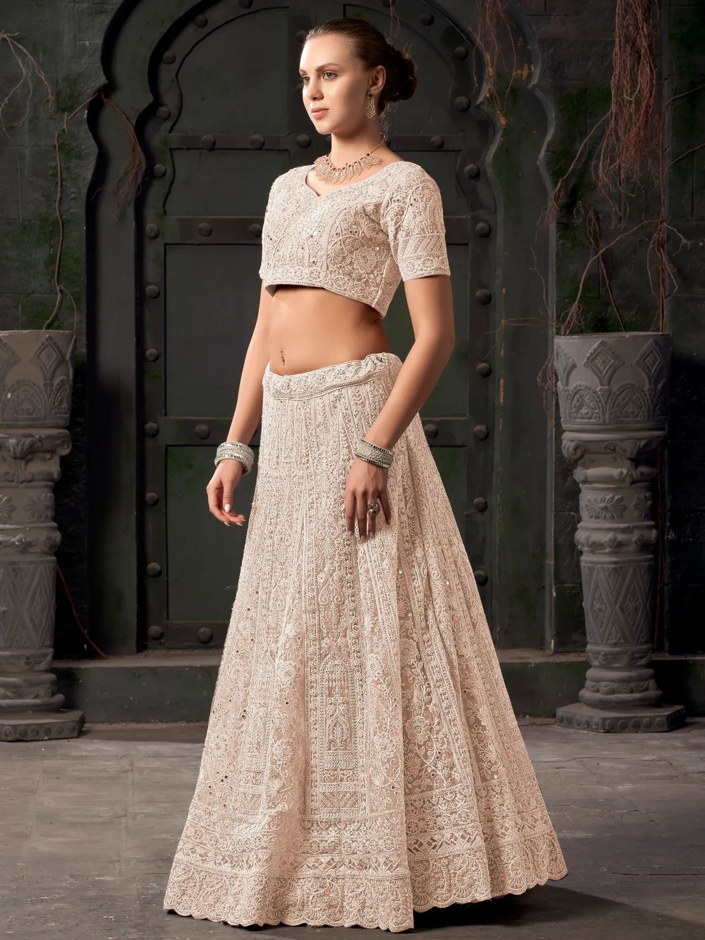 Elegant ivory lehenga choli with intricate lace embroidery, perfect for Indian ethnic occasions