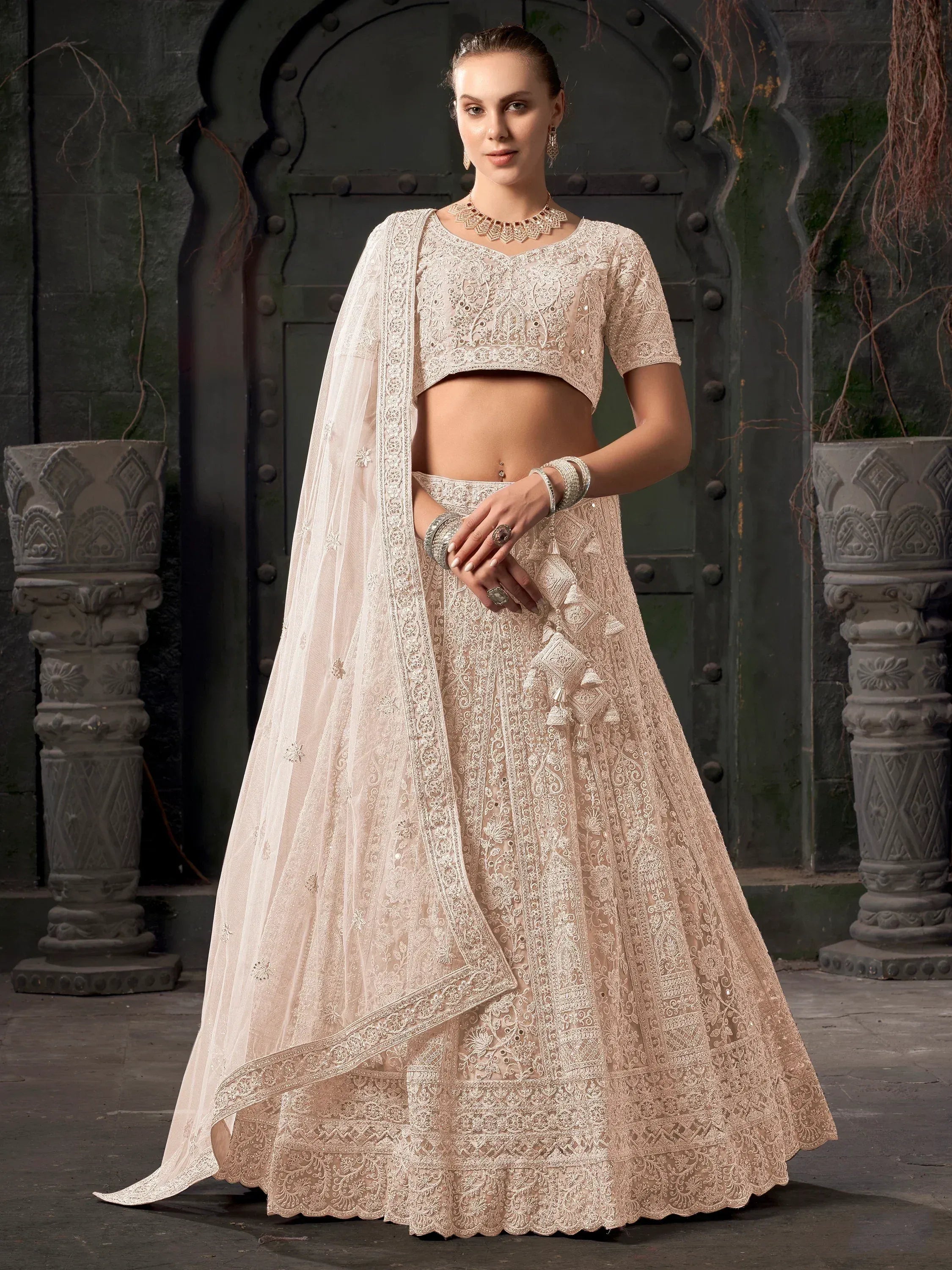 Elegant beige embroidered lehenga choli with dupatta, perfect for Indian weddings and festive occasions.
