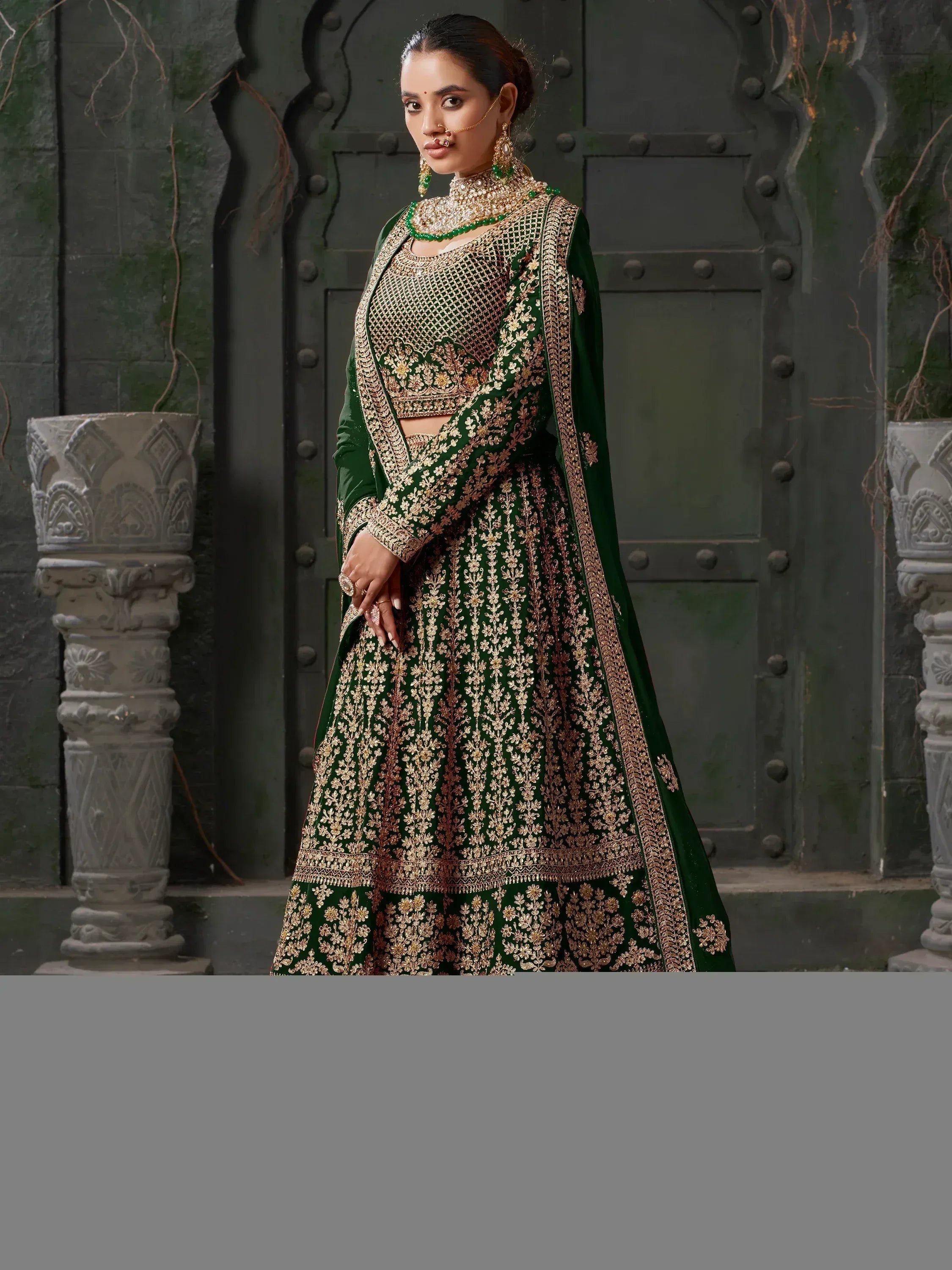 Emerald green designer lehenga choli with gold embroidery, perfect for Indian weddings and festive occasions.