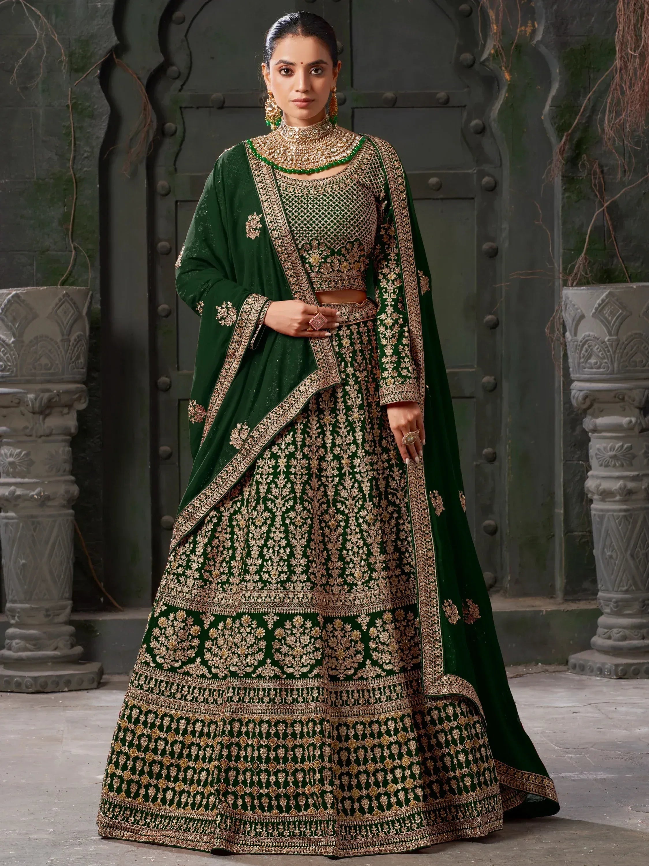 Emerald green designer lehenga choli with gold embroidery, perfect for Indian weddings and festive occasions.