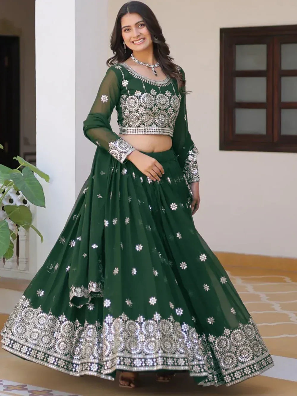 Emerald green designer lehenga choli with silver embroidery, perfect for Indian ethnic wear occasions.