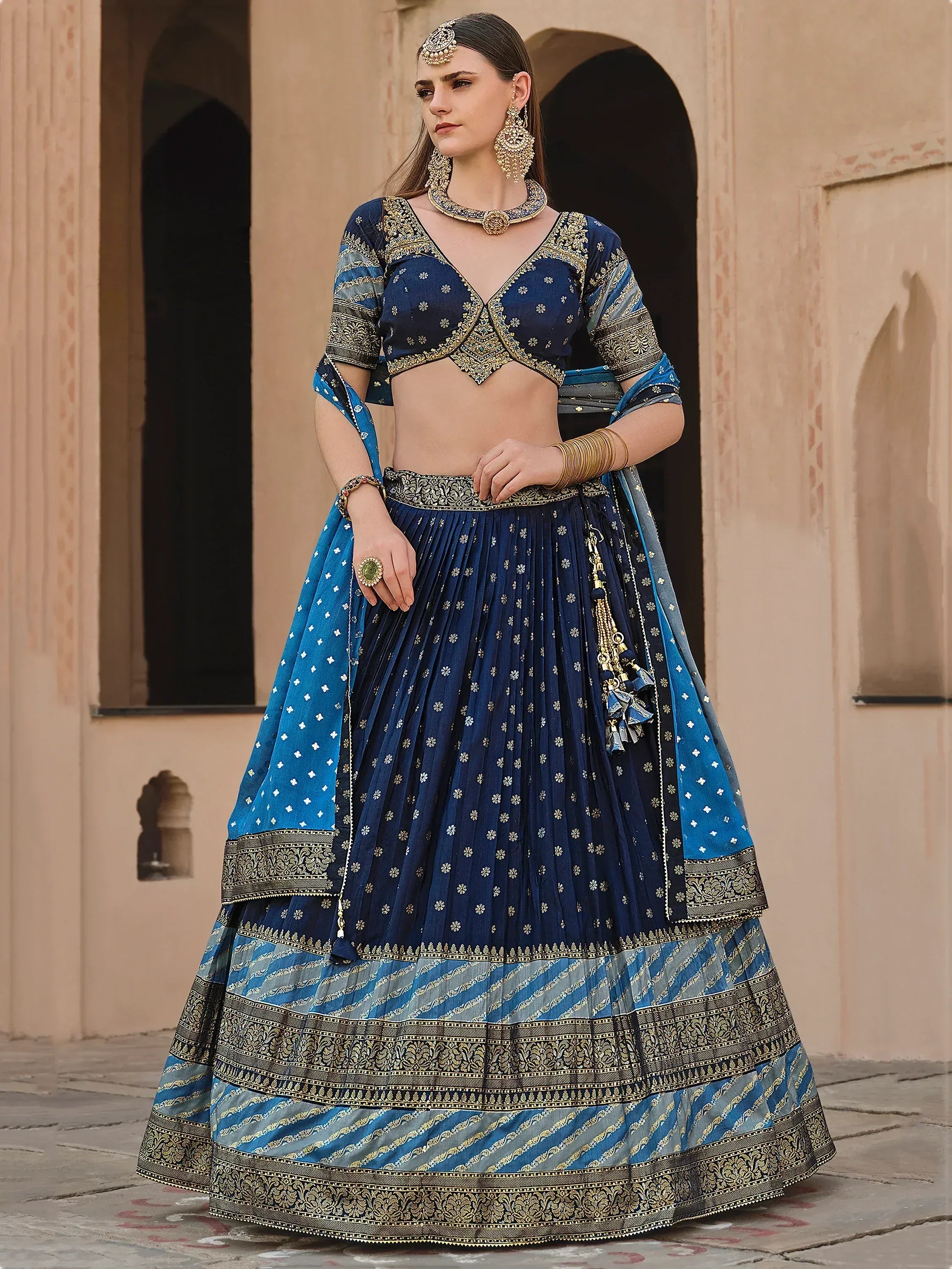 Blue designer lehenga choli with gold embroidery, perfect for Indian ethnic wear and festive occasions.