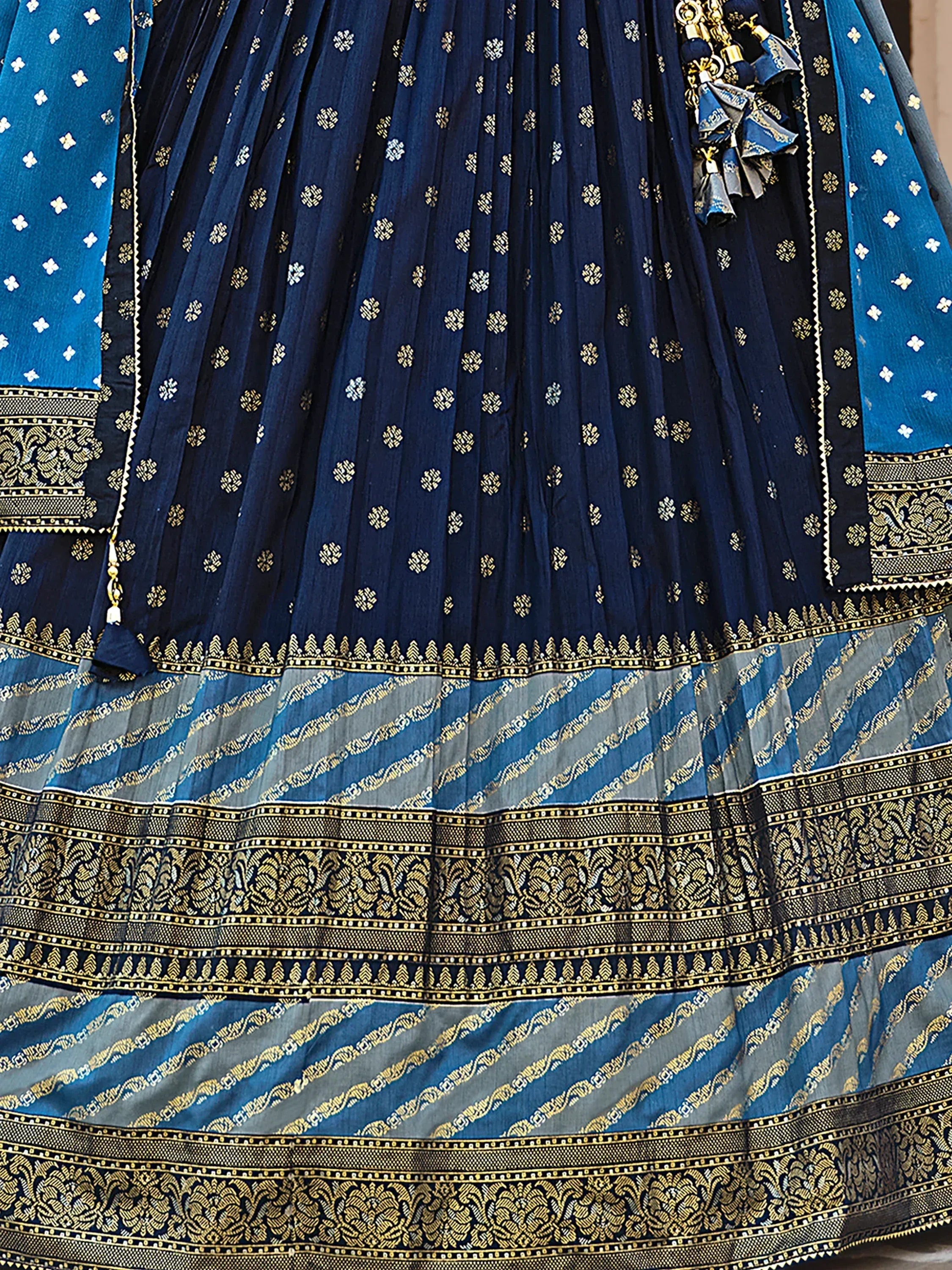 Navy blue and teal ethnic lehenga with gold floral embroidery and pleated skirt detail