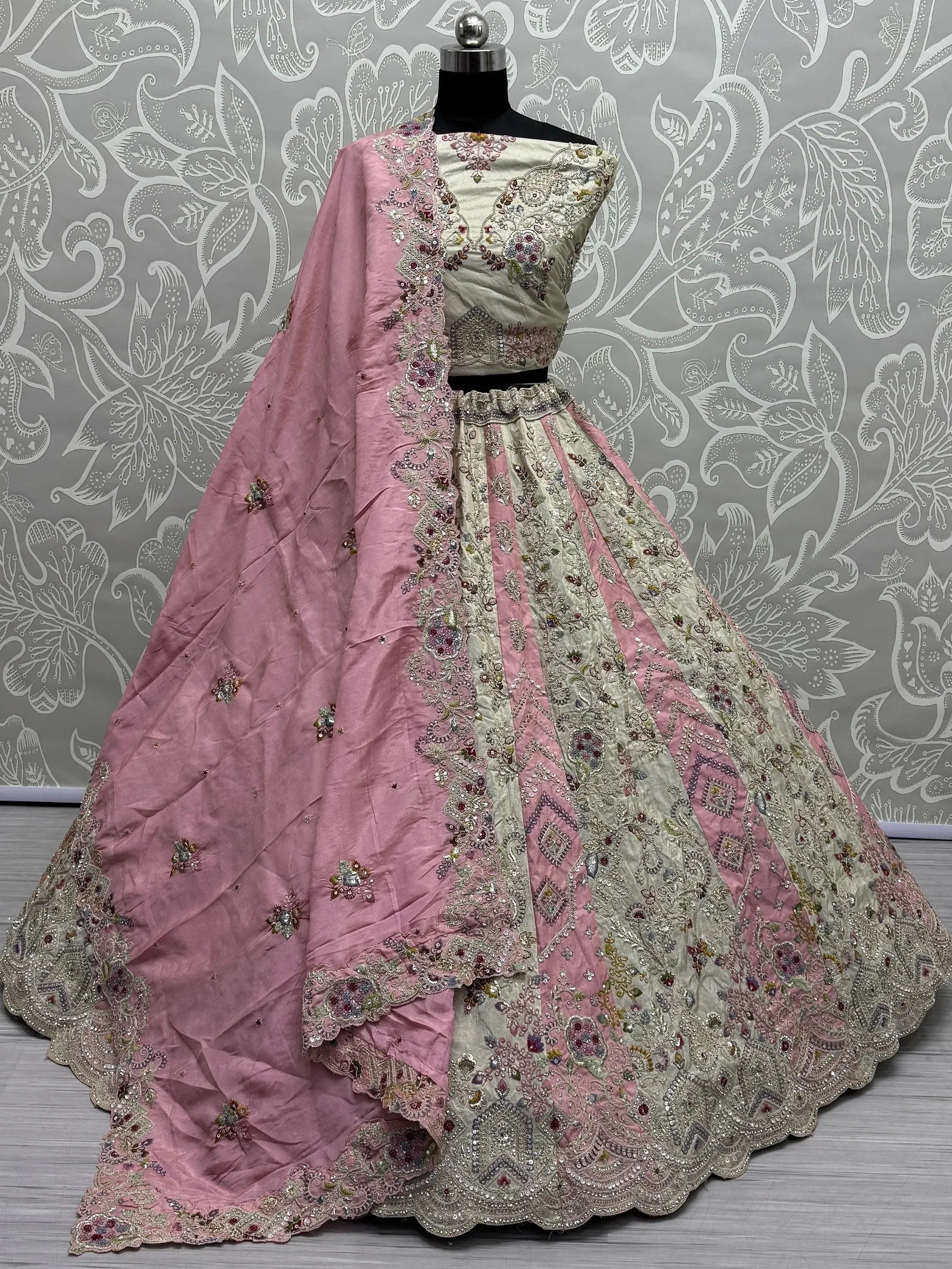 Pink and cream embroidered lehenga choli with floral detailing, perfect for Indian ethnic wear occasions.
