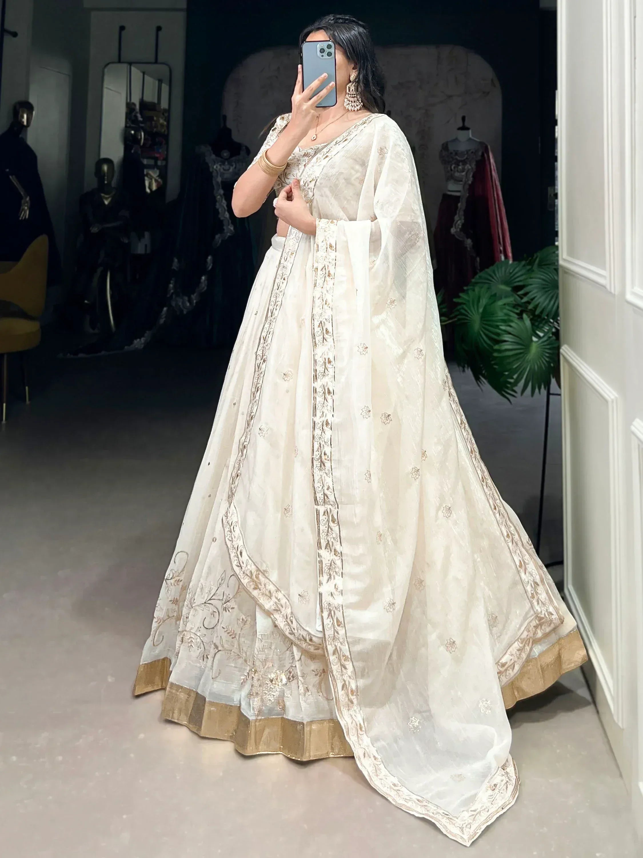 Elegant ivory lehenga choli with gold embroidery, perfect for Indian weddings and festive occasions.