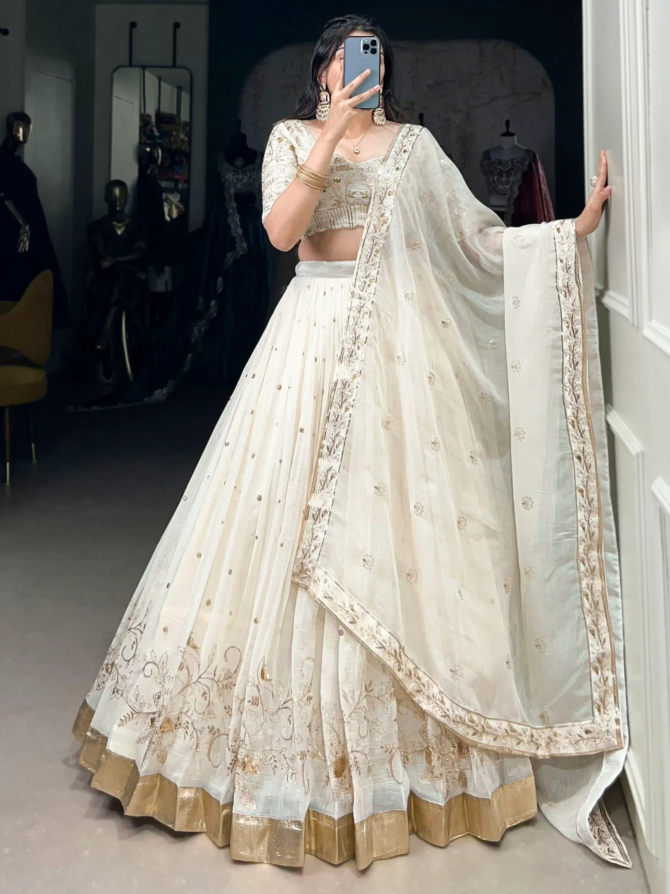 Elegant white lehenga choli with gold embroidery, perfect for Indian weddings and festive occasions.