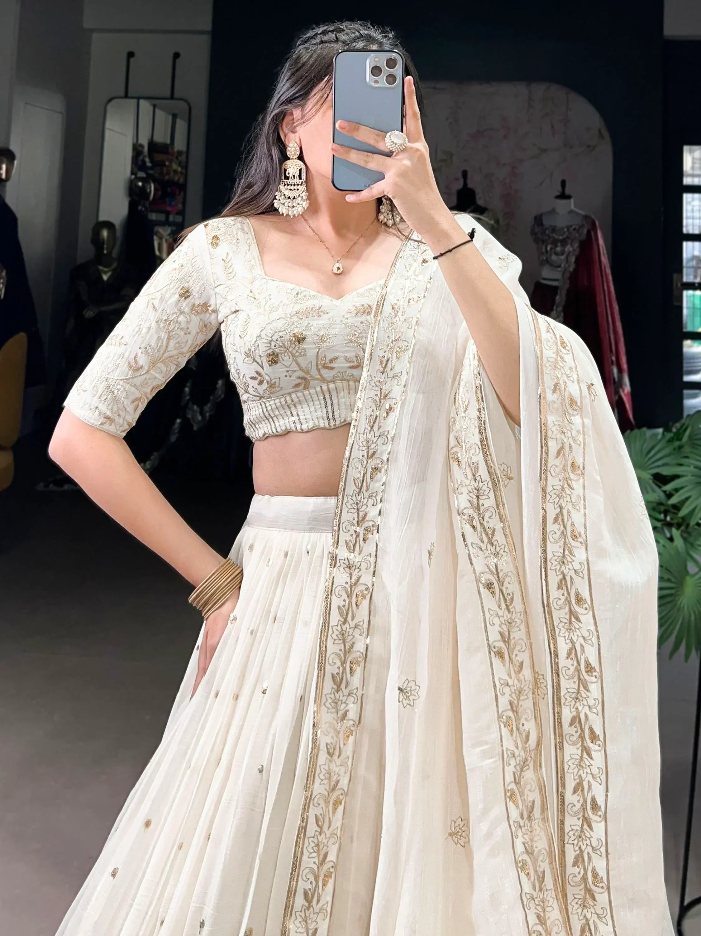 Elegant white lehenga choli with gold embroidery, perfect for Indian ethnic wear occasions.