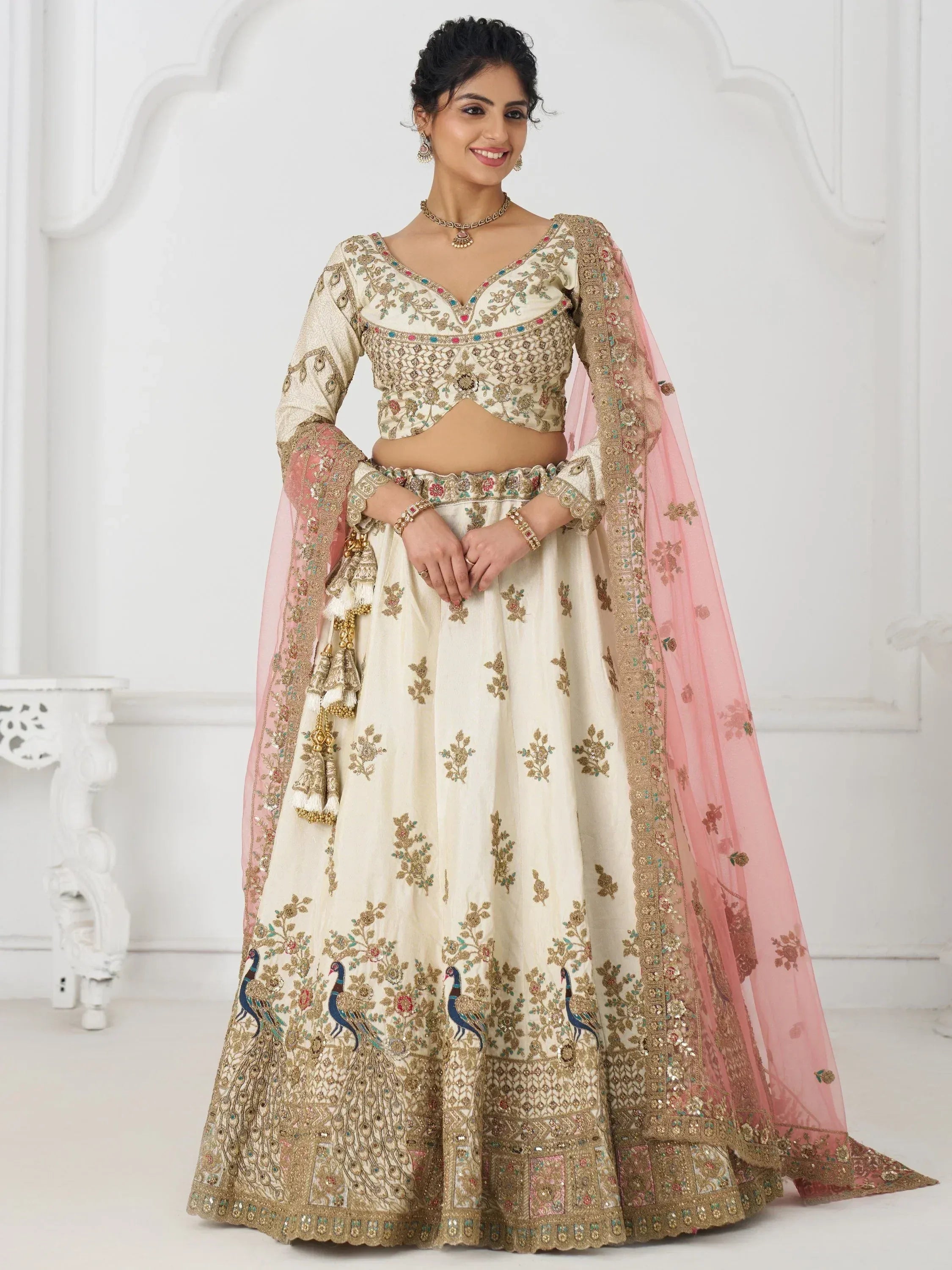 Cream embroidered lehenga choli with peacock motifs and pink dupatta, Indian ethnic wear
