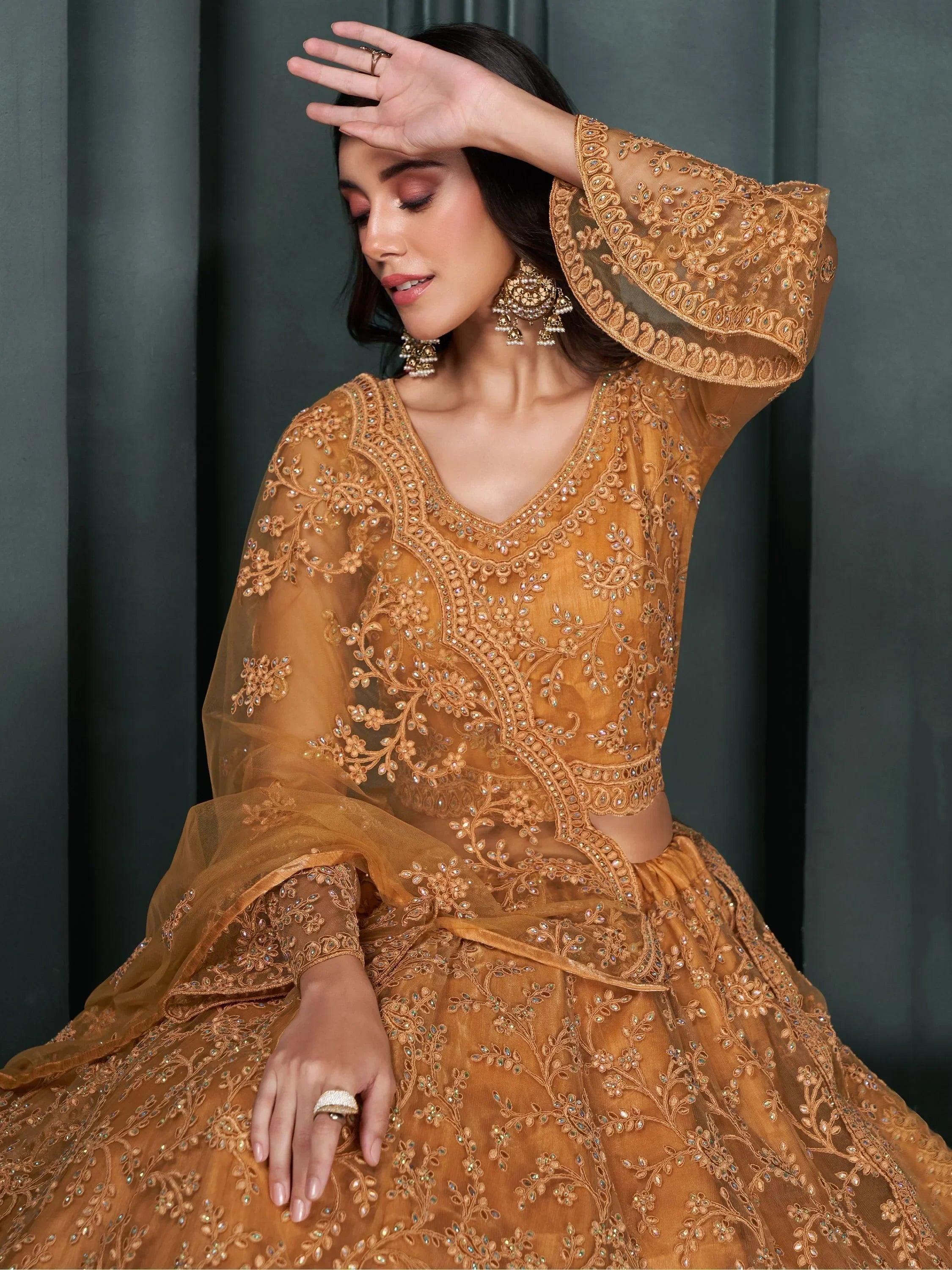 Elegant mustard yellow embroidered lehenga choli with bell sleeves, perfect for Indian weddings and festive occasions.
