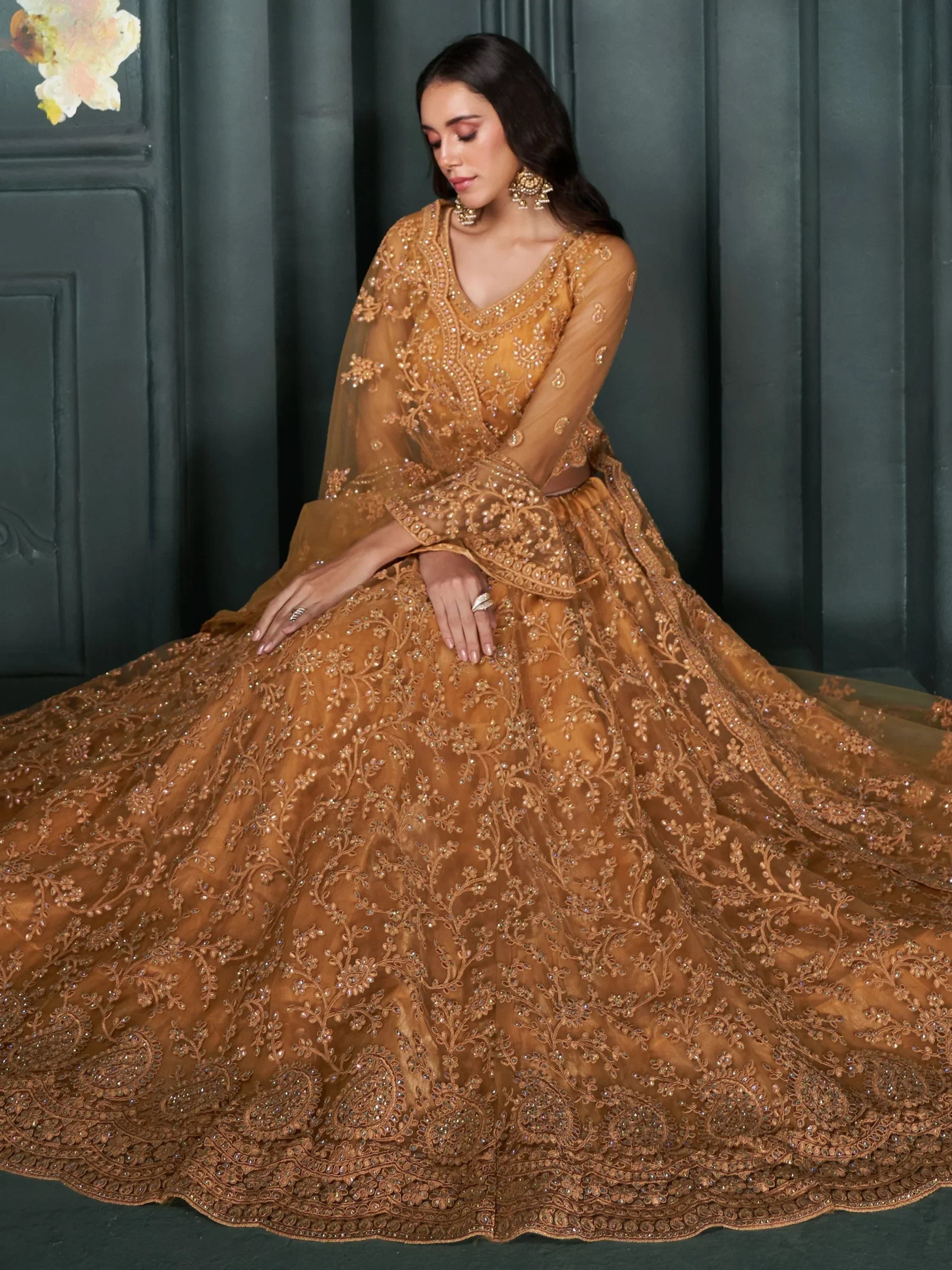 Elegant mustard yellow designer lehenga choli with intricate embroidery and embellishments, perfect for Indian ethnic wear.