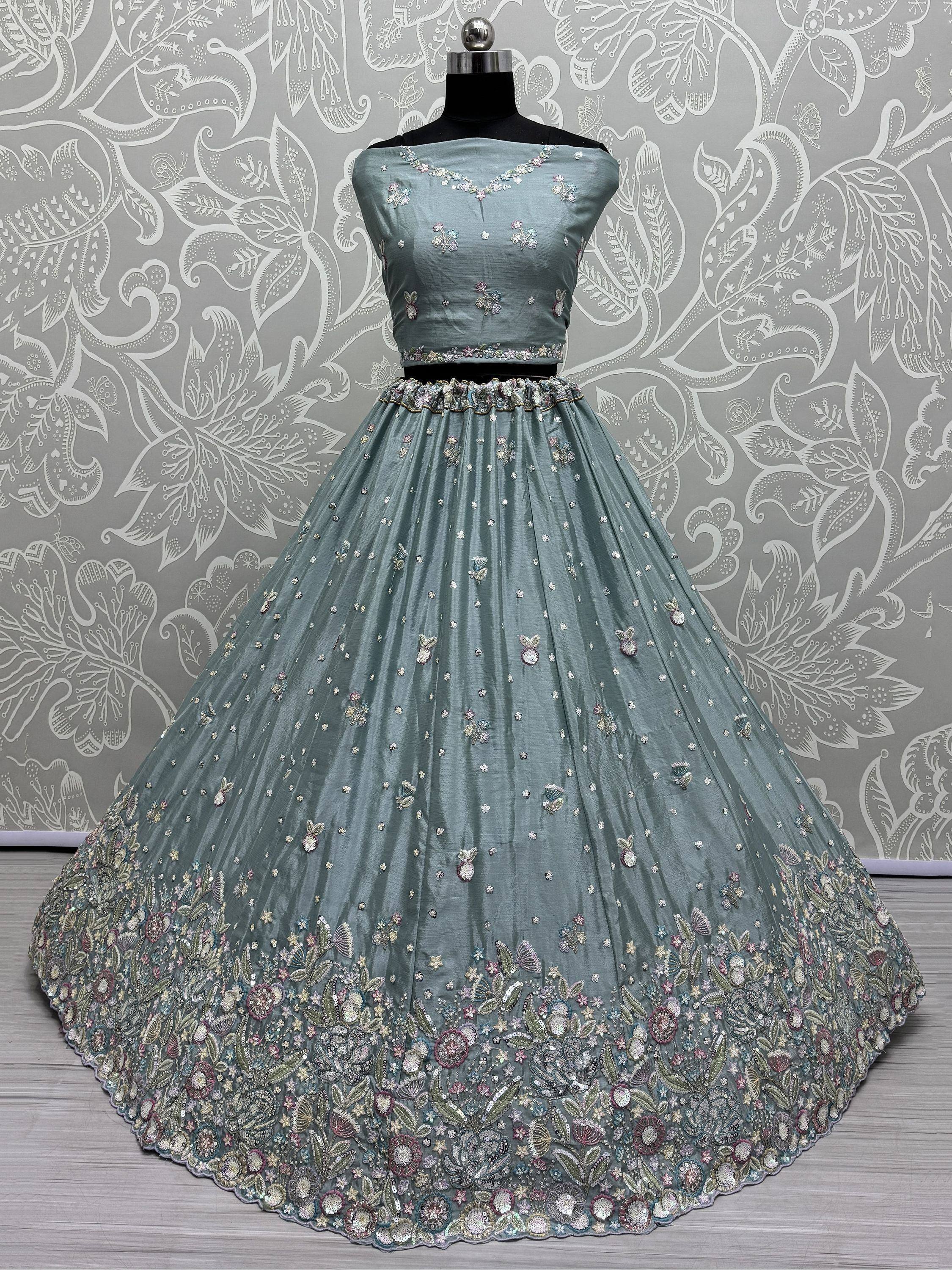Dusty blue designer lehenga choli with floral embroidery and sequin work, perfect for weddings and parties.