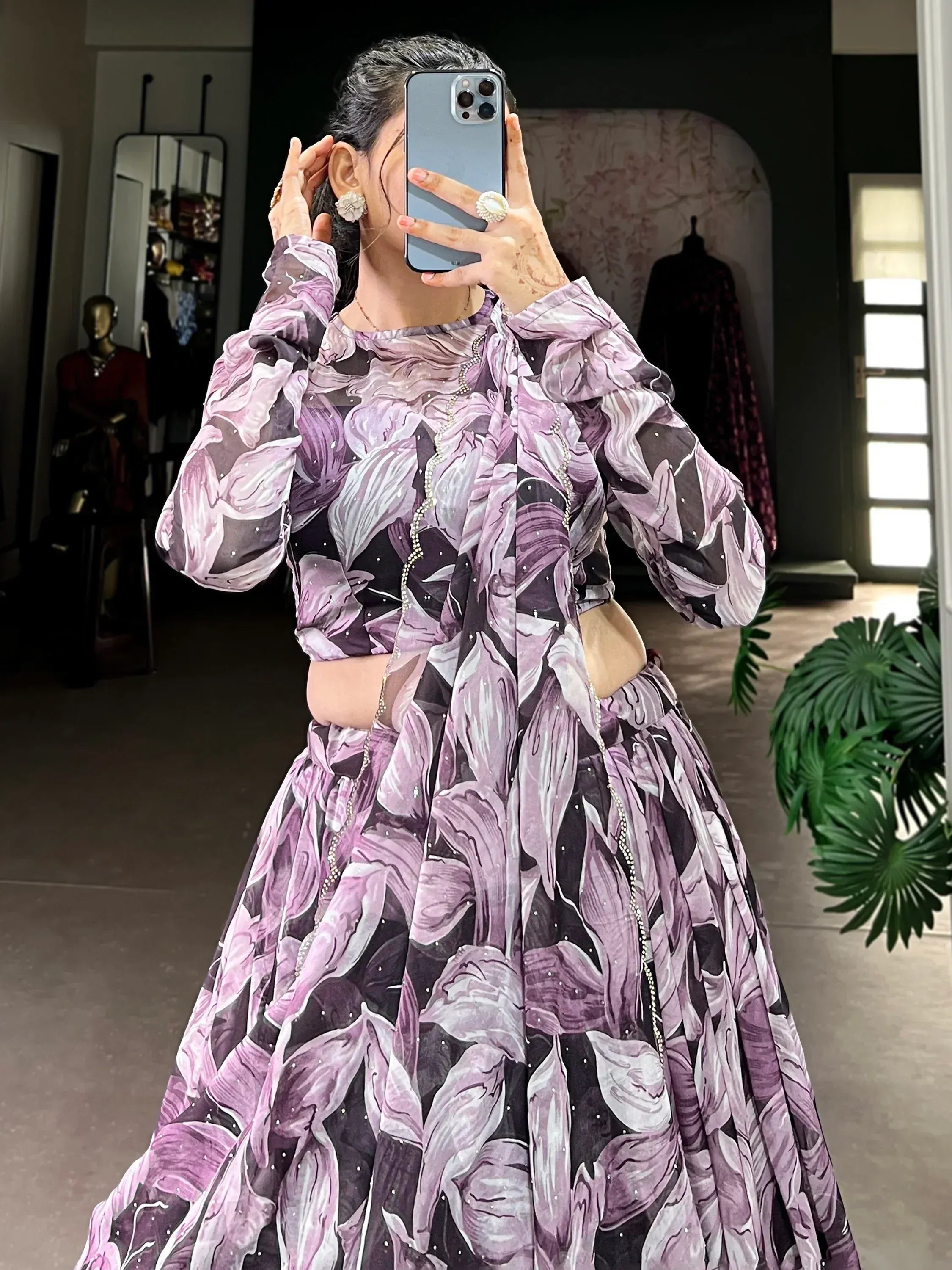 Purple floral print lehenga choli with sheer sleeves and embellishments, perfect for Indian ethnic wear occasions.