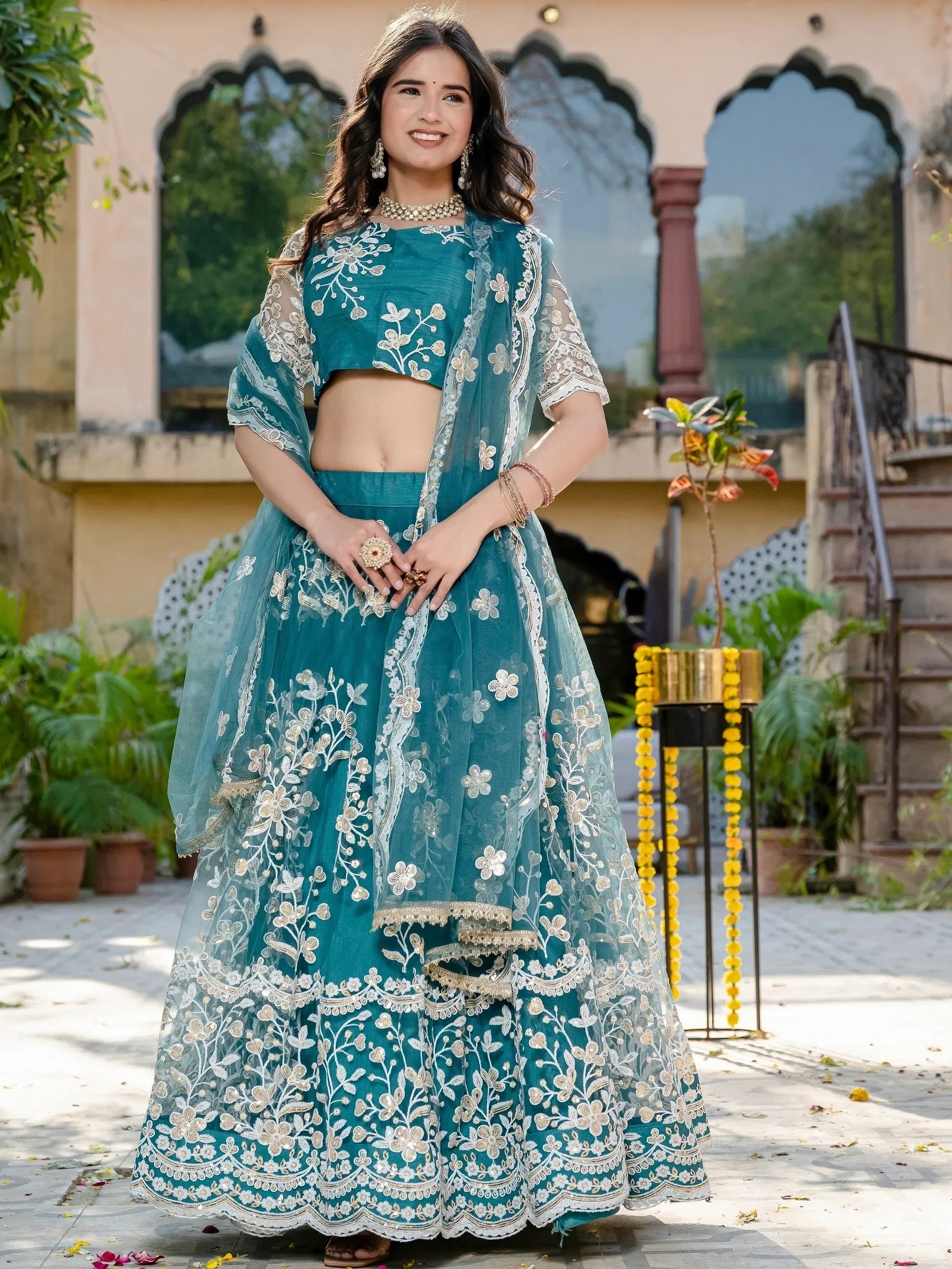 Teal embroidered lehenga choli with floral motifs, perfect for Indian ethnic occasions