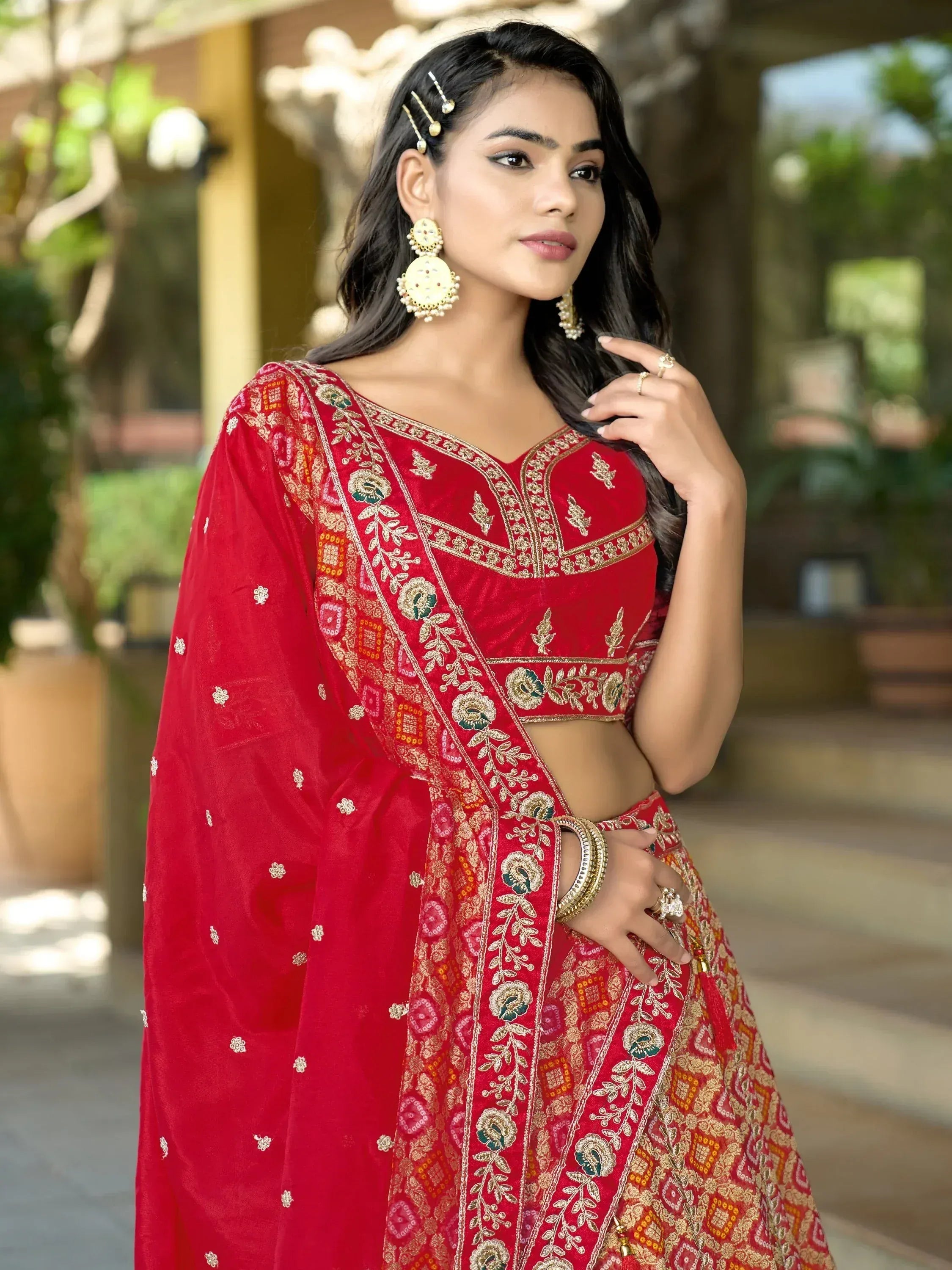 Red embroidered lehenga choli with gold detailing, perfect for Indian ethnic wear and festive occasions.