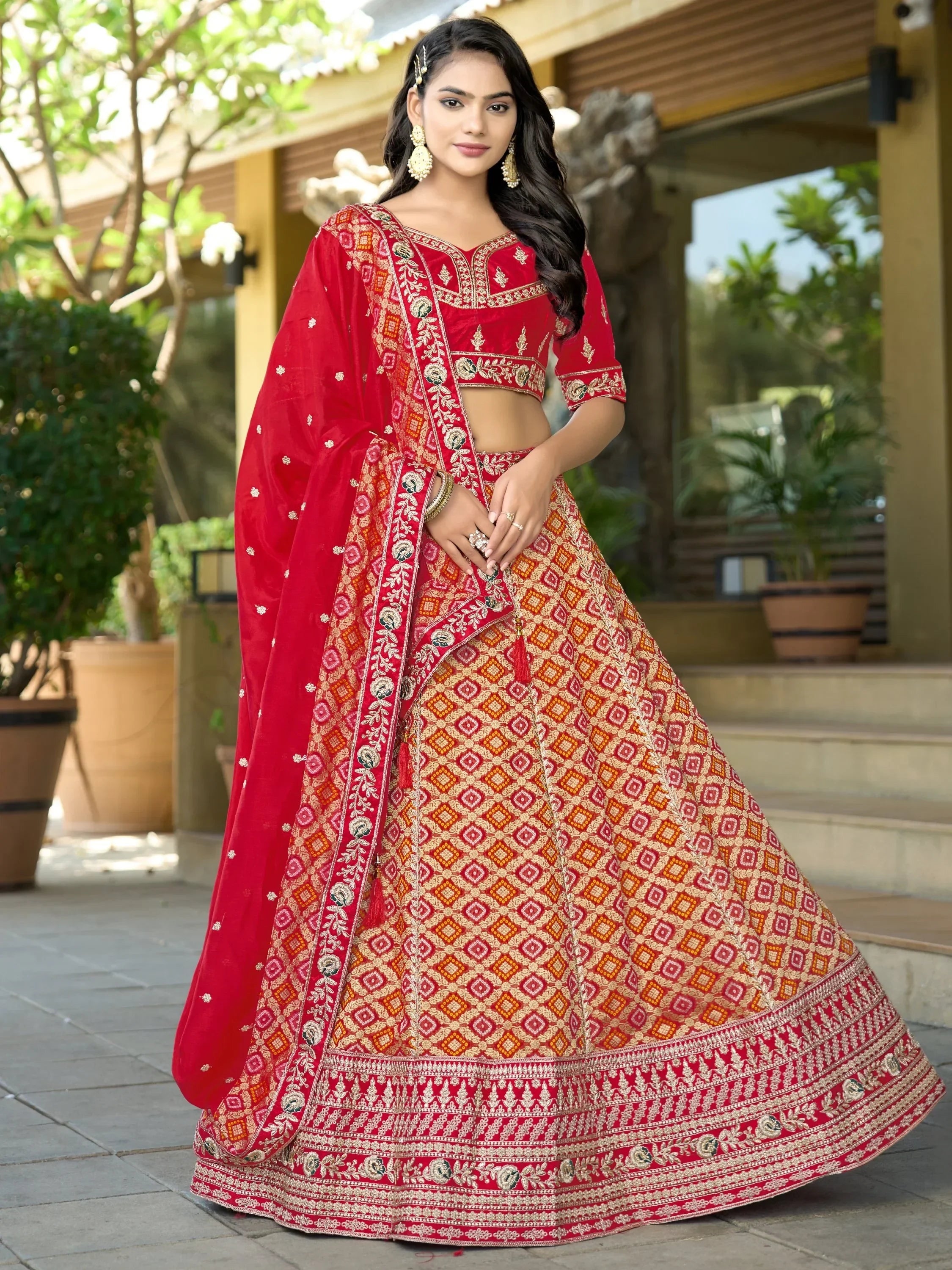 Red embroidered lehenga choli with gold patterns, perfect for Indian weddings and festive occasions