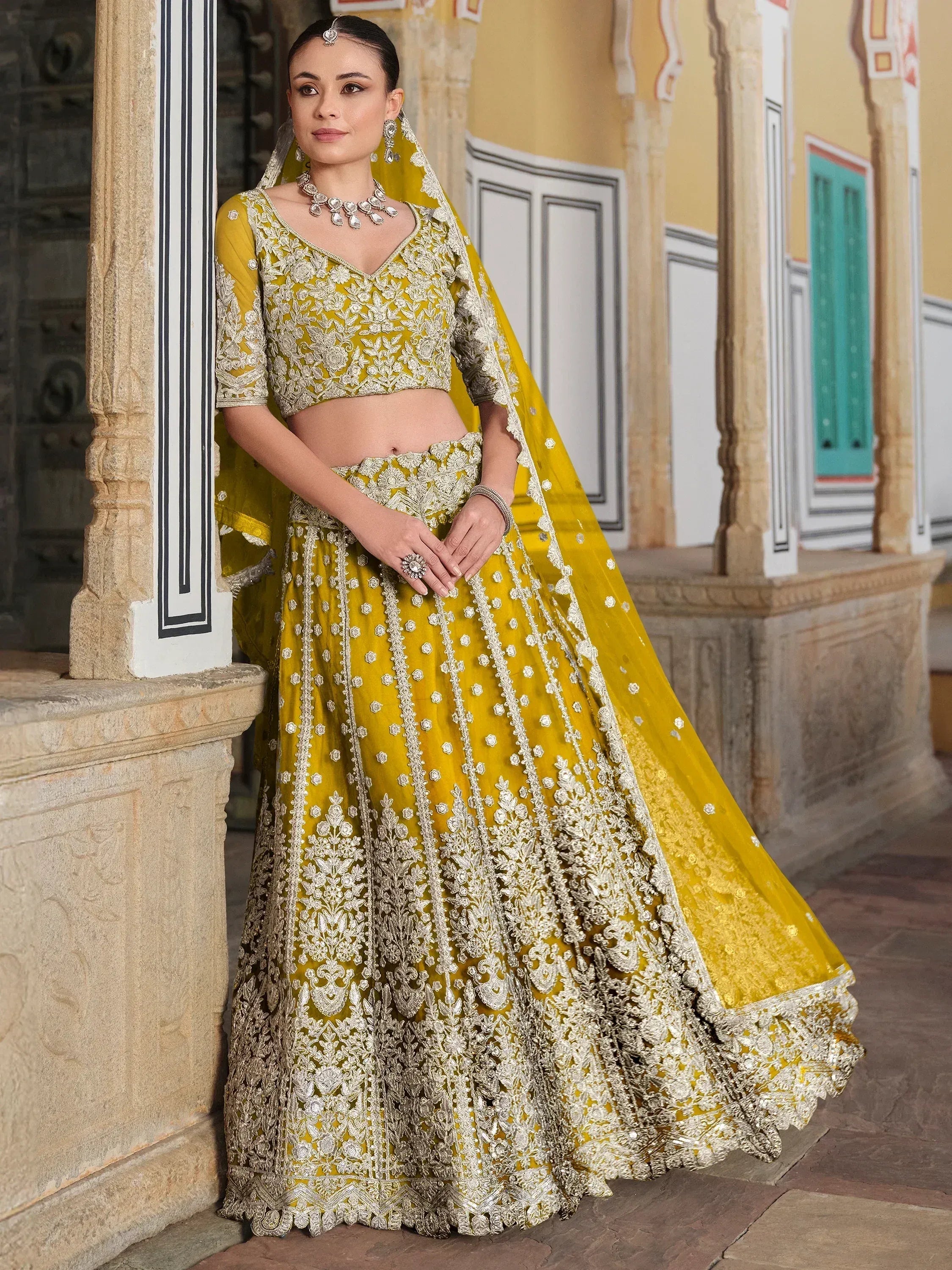 Yellow designer lehenga choli with heavy silver embroidery, perfect for Indian weddings and ethnic events
