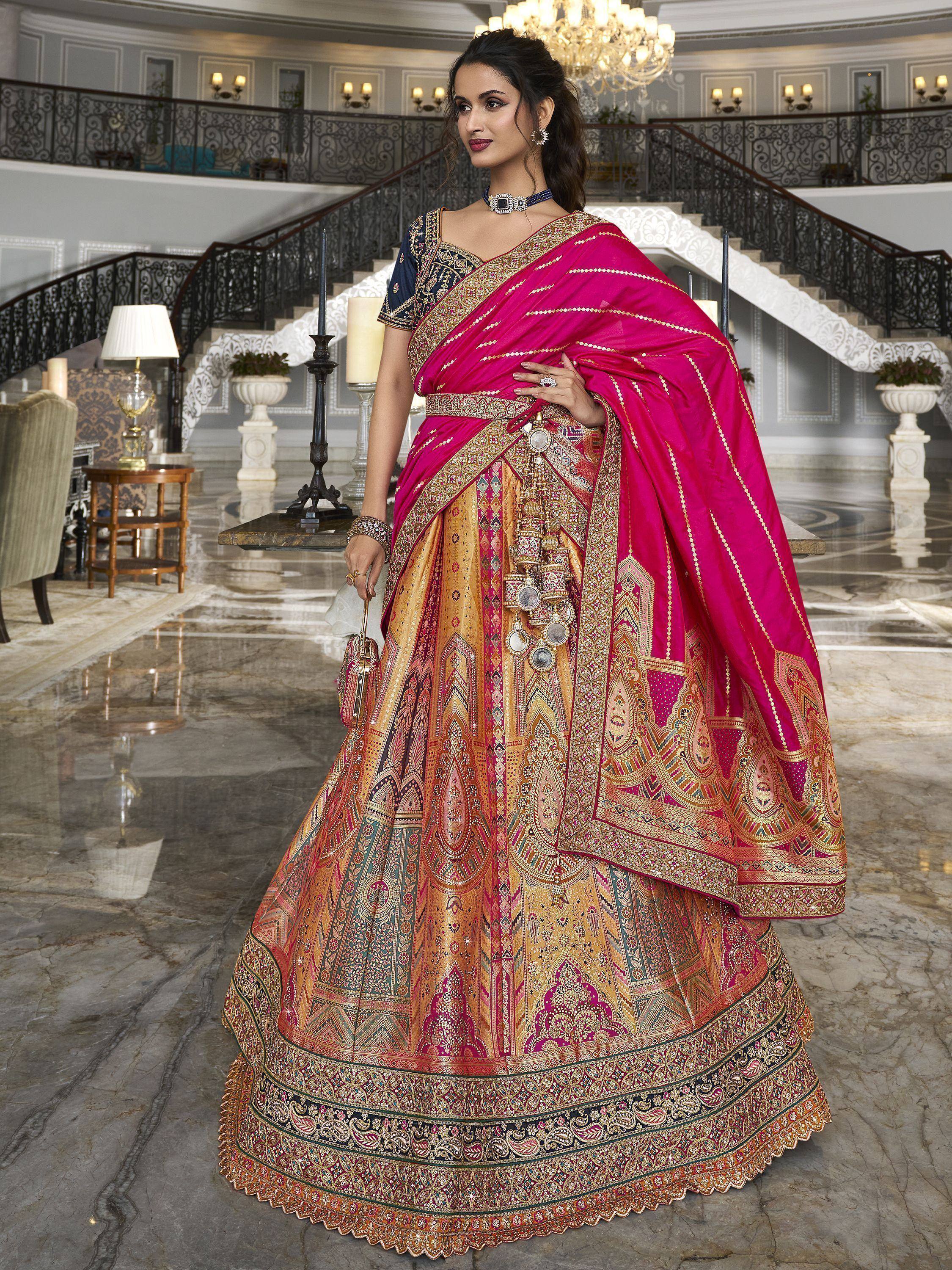 Elegant pink and gold embroidered lehenga choli with intricate designs, perfect for Indian weddings and festive occasions.