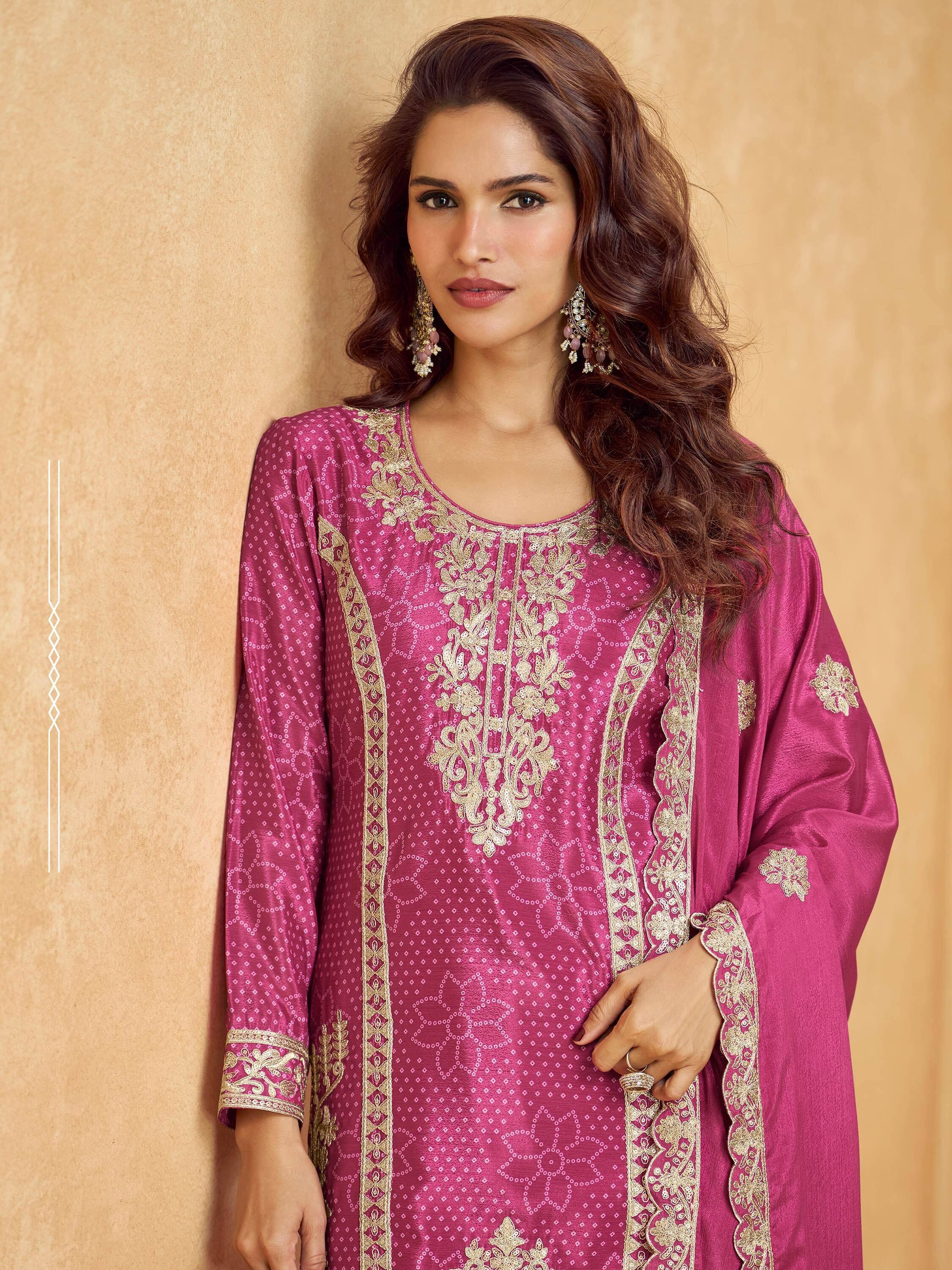 Elegant pink ethnic kurti with gold embroidery and floral patterns, perfect for festive occasions.
