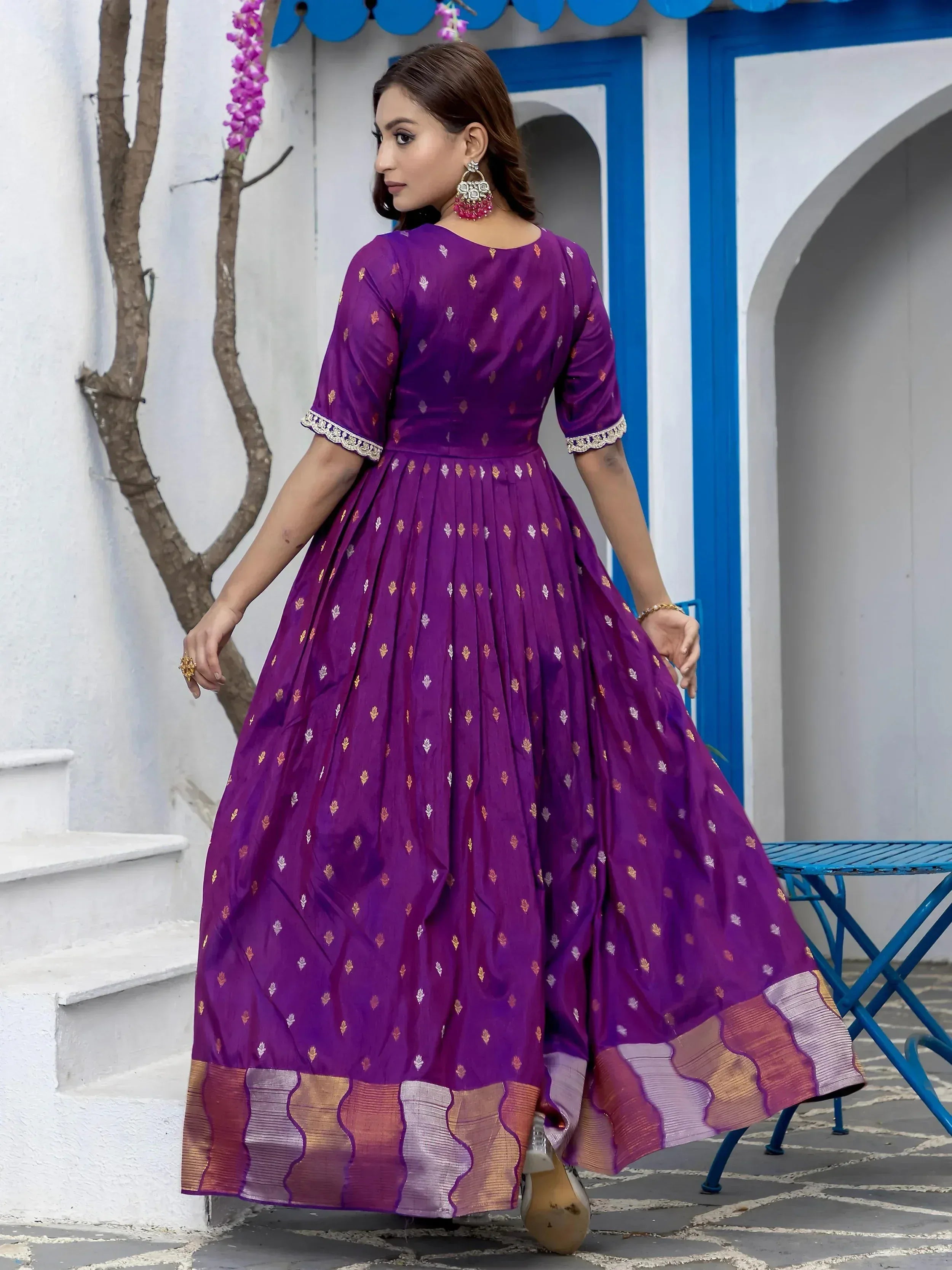 Purple ethnic gown with gold motifs and pleated skirt, perfect for Indian festive occasions