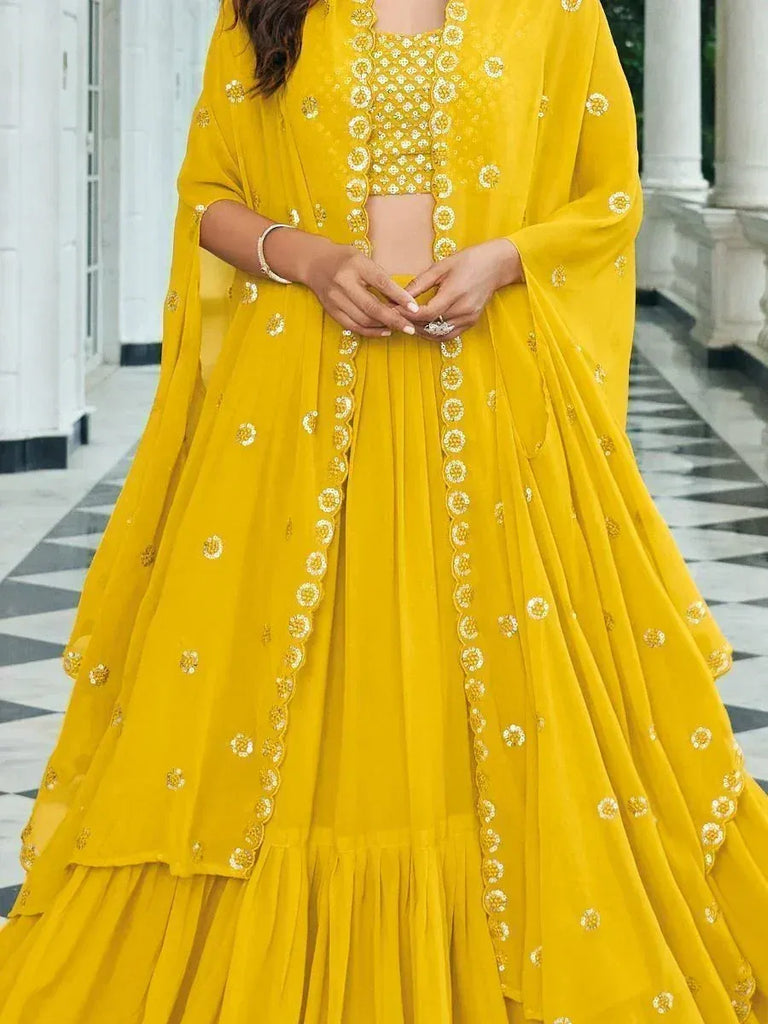 Vibrant yellow designer lehenga choli with floral embroidery, perfect for Indian ethnic occasions.