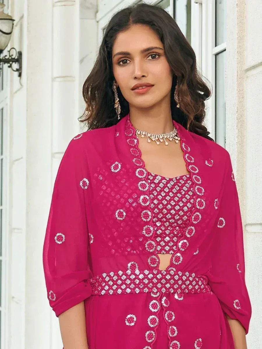 Pink embroidered ethnic gown with white floral motifs, perfect for Indian occasions