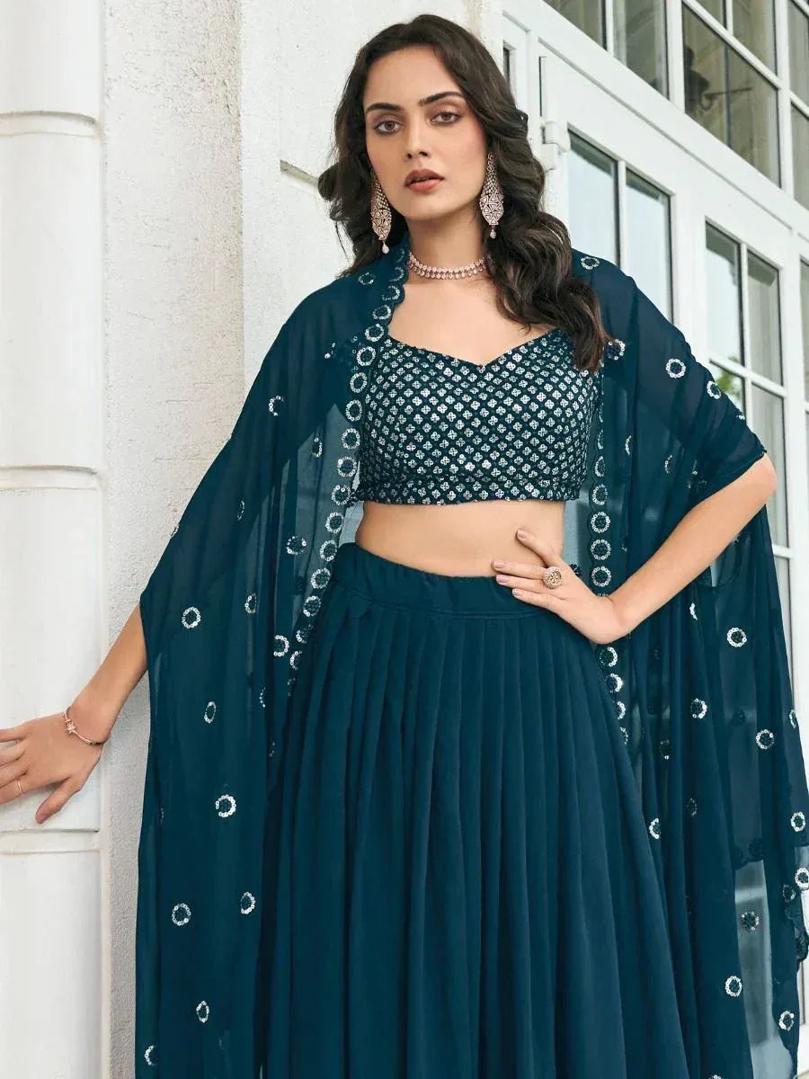 Teal embroidered lehenga choli with sheer cape, perfect for Indian ethnic wear occasions