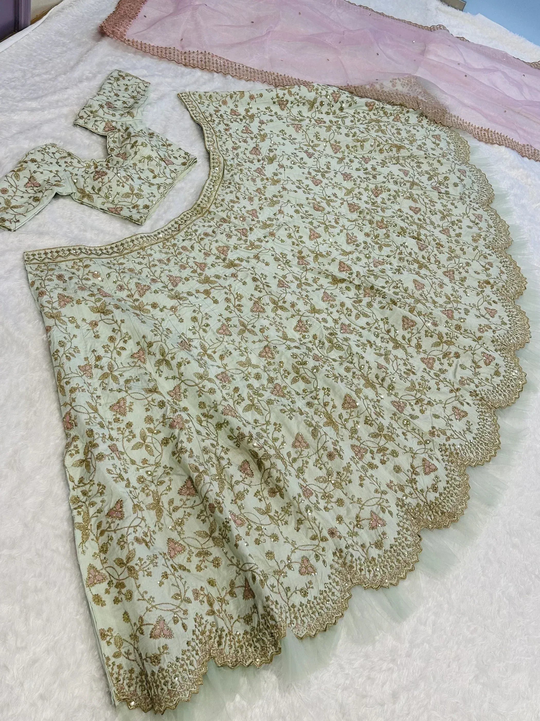 Light green embroidered lehenga choli with floral gold detailing and scalloped hem