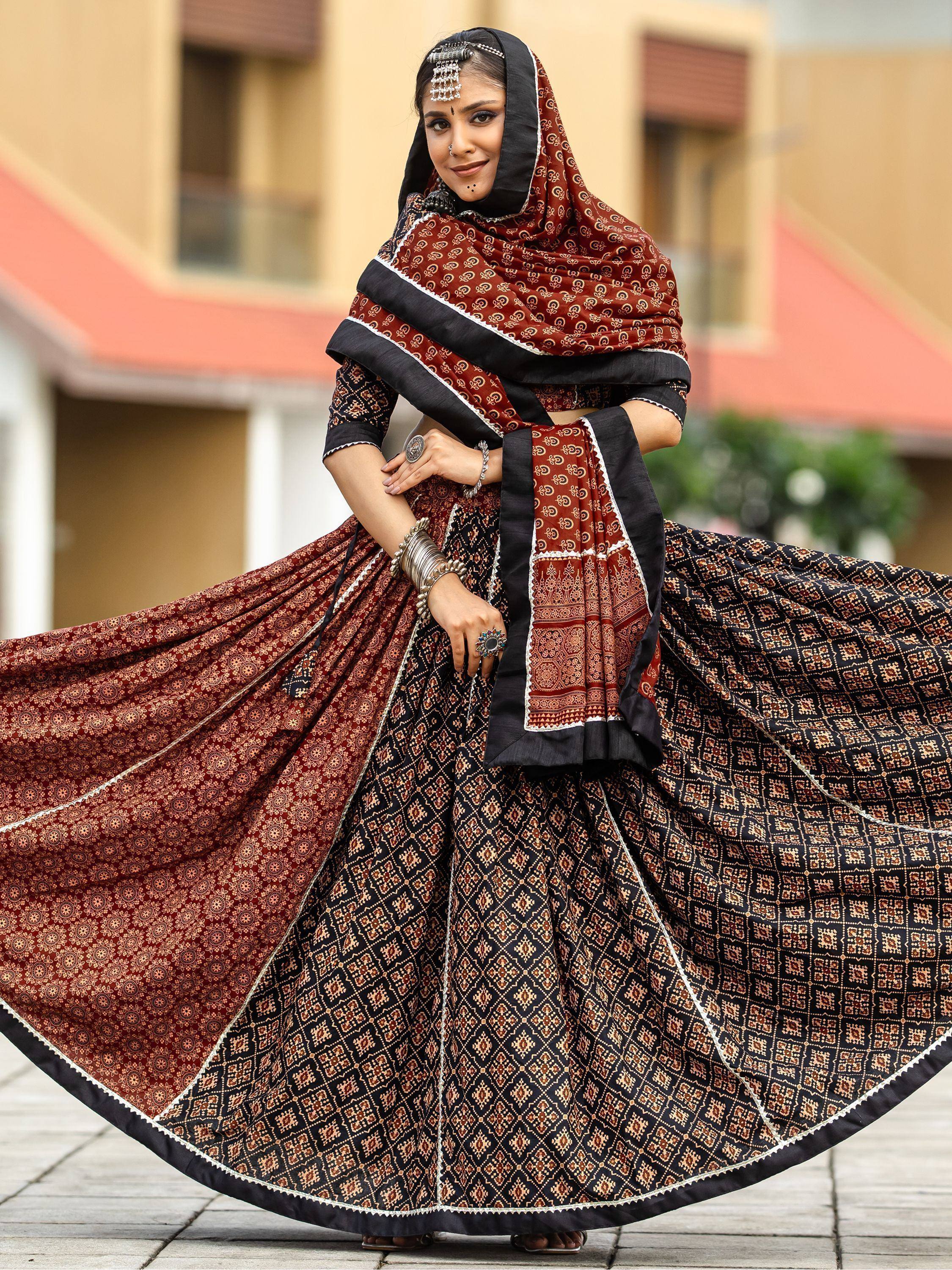 Elegant maroon and black printed lehenga choli with traditional jewelry and dupatta