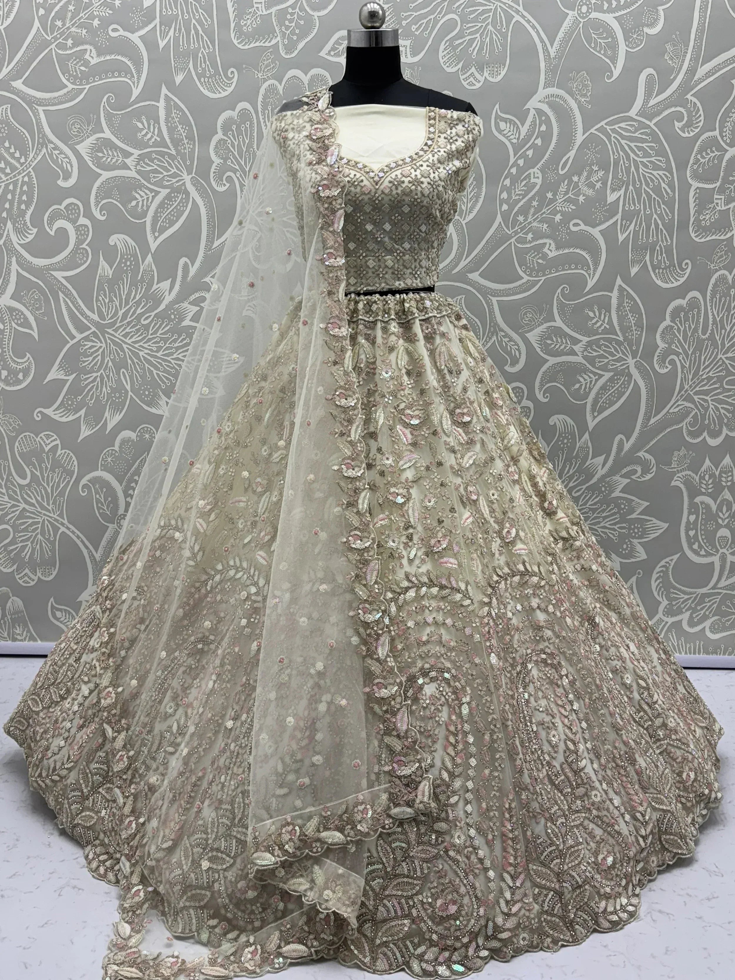 Elegant beige lehenga choli with intricate floral embroidery and sequin detailing, perfect for Indian ethnic wear.