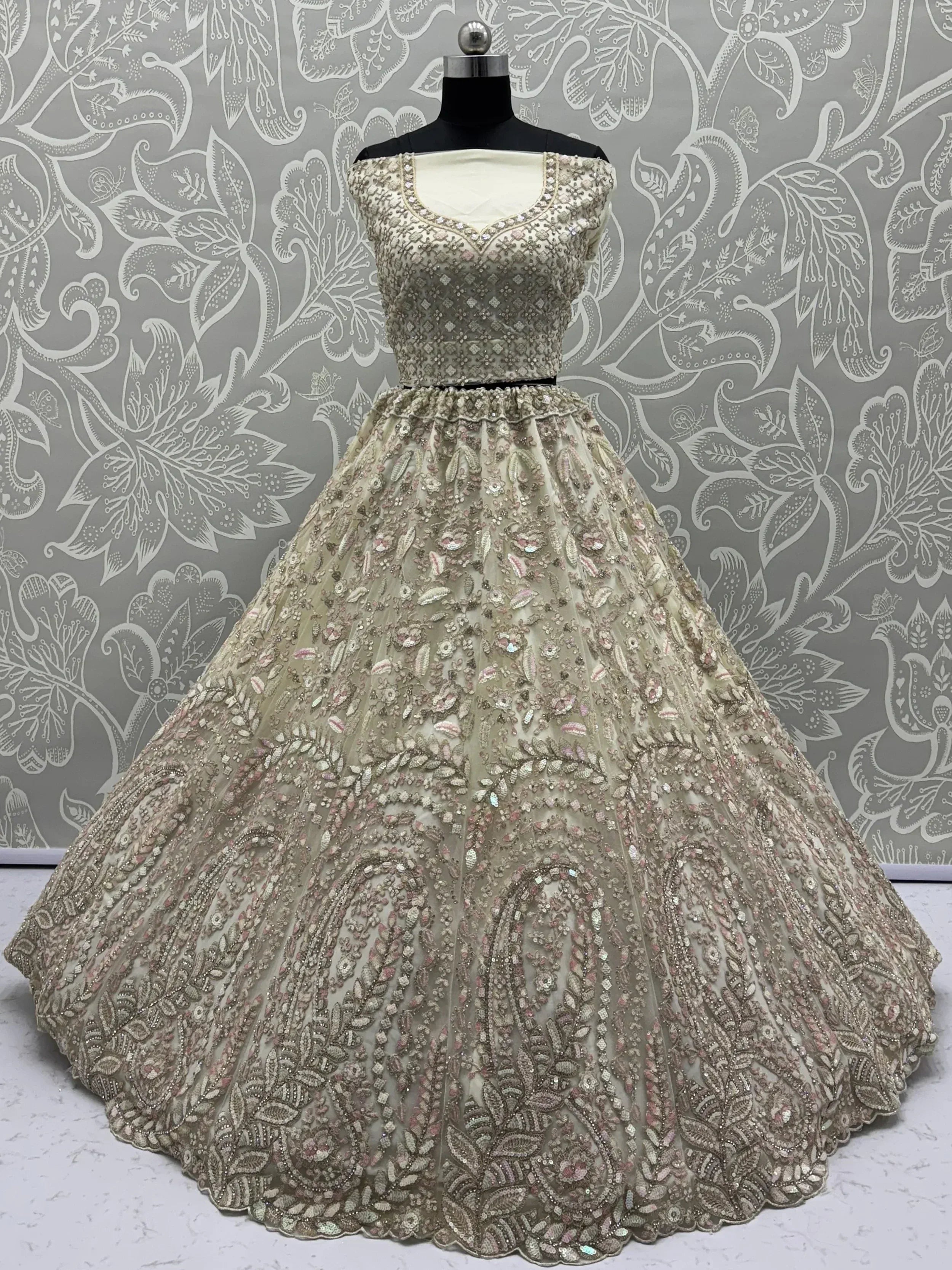 Elegant beige embroidered lehenga choli with floral motifs, perfect for Indian weddings and festive occasions.