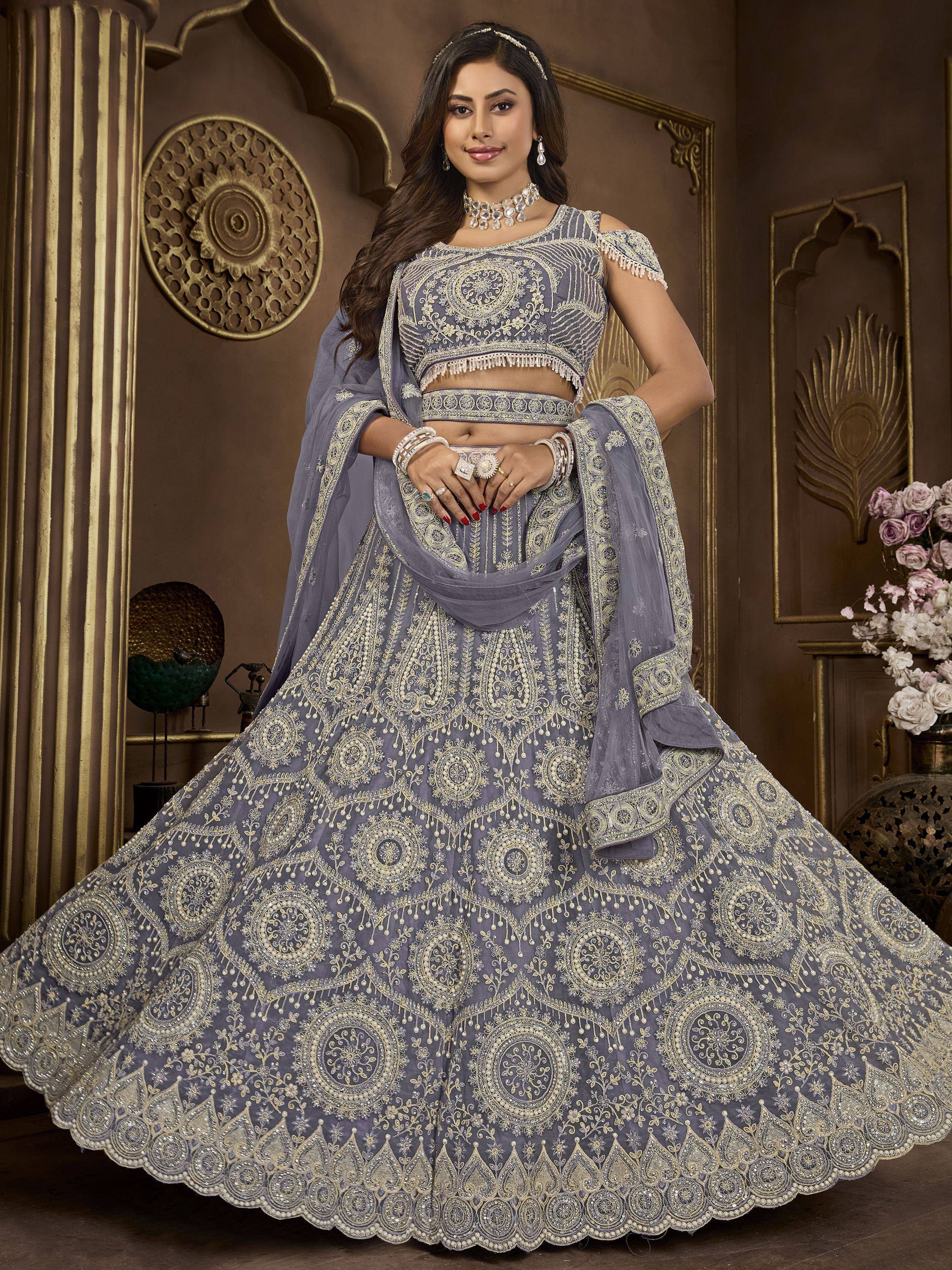 Grey designer lehenga choli with heavy gold embroidery and dupatta, perfect for weddings and festive occasions.